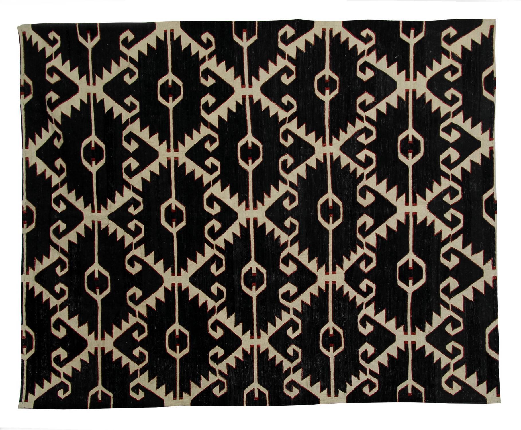This black and white rug is astonishing because of the peculiarity of the woven rug design. The main color of the flat weave rug is black which is broken up by white lines of various shapes. The lines transport your imagination into a different