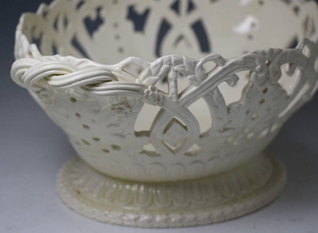 Good size decorative antique creamware pottery basket with rope twist handles.
The open work basket is decorated with leaves and scrolls and is modelled on an oval plinth shaped base. Late 18th century Staffordshire or Yorkshire, England.