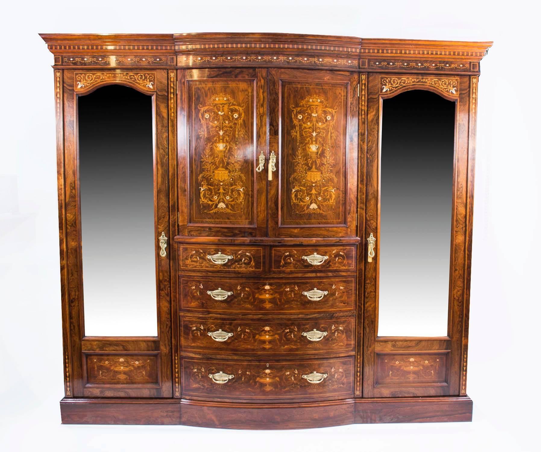 This is a spectacular antique Victorian inlaid rosewood bedroom suite comprising, a wardrobe, dressing table, bedside cabinet and three chairs made by the renowned Victorian retailer and cabinet maker Edwards & Roberts, circa 1880 in date. 

Each