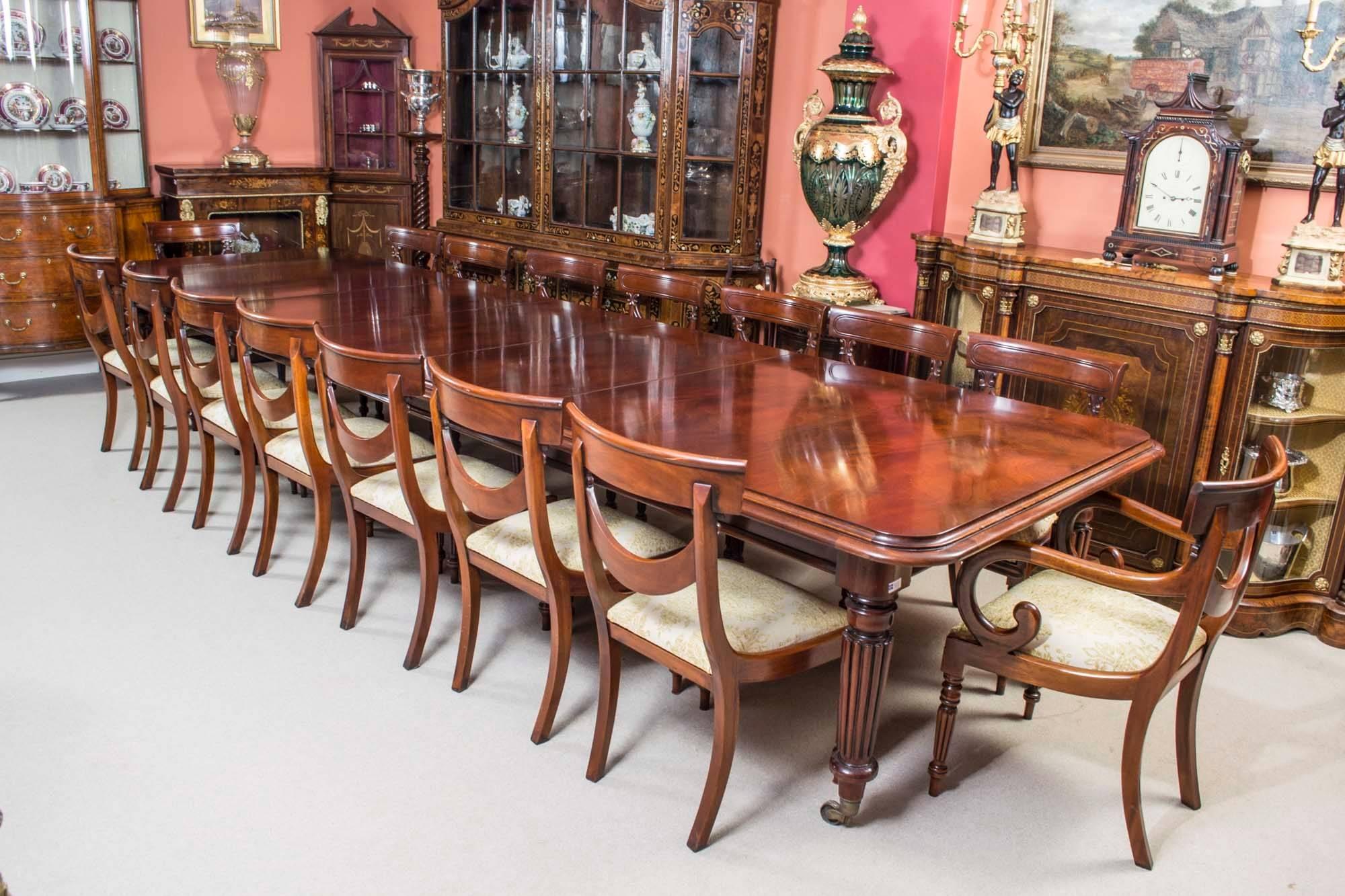This is a fantastic vintage Victorian style dining set of dining table complete with sixteen matching drape back chairs. 

This flame mahogany dining table has three leaves, they measure 60 cm each and can be added or removed as required to suit