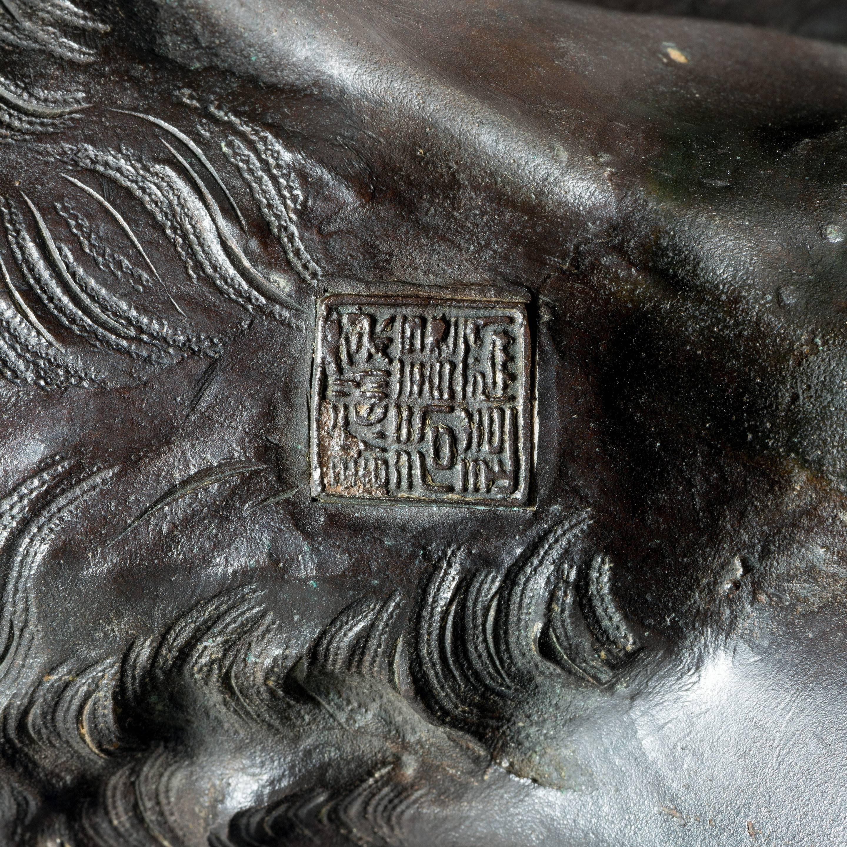 A very fine bronze tiger by Genryusai Seiya, 

The bronze body patinated to imitate the distinctive stripes of a tiger’s skin, with inset orange glass eyes. Signed in a seal Seiya sei.  
