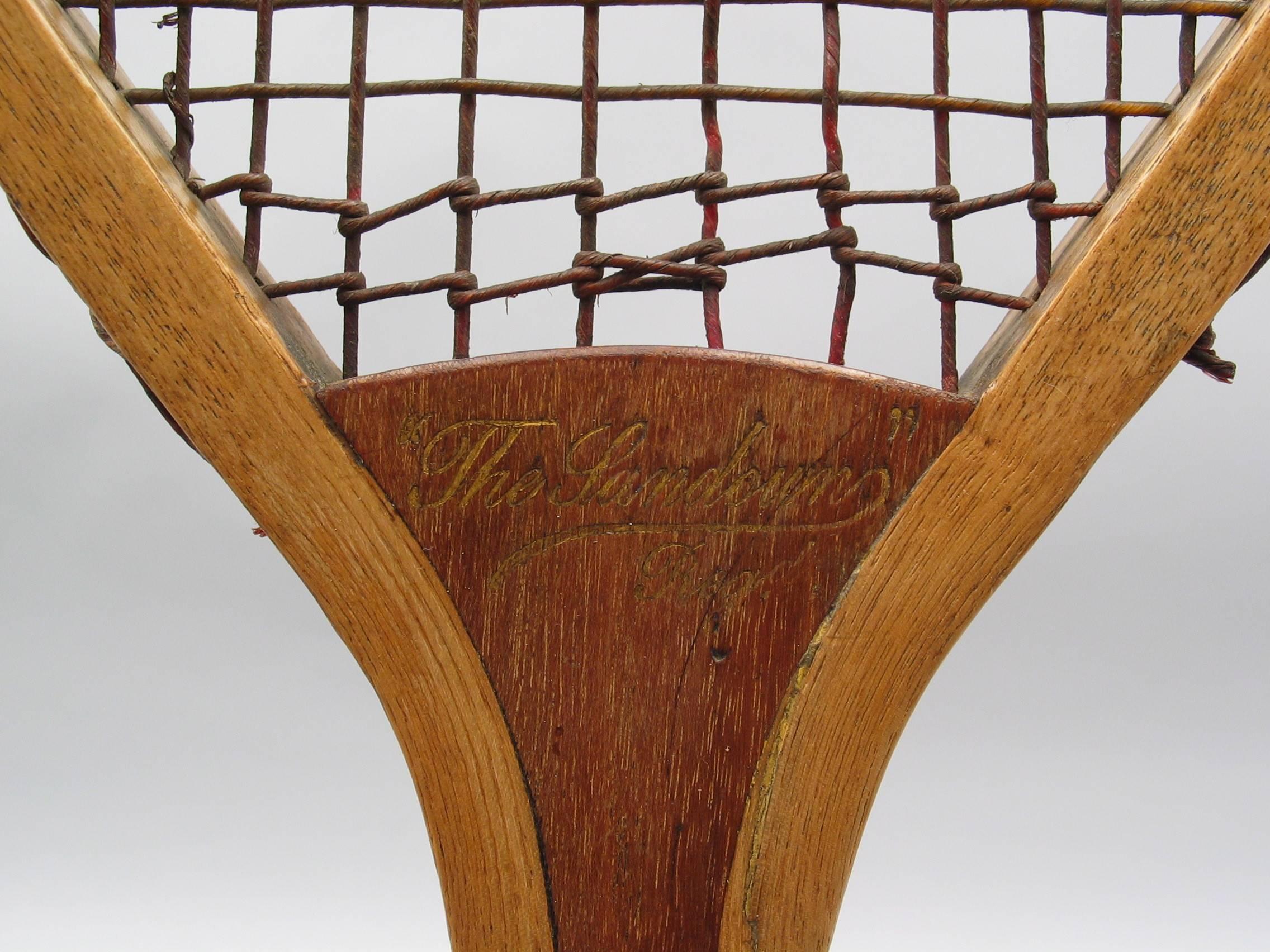 A fine early flat top lawn tennis racket. The convex wedge embossed with the words 