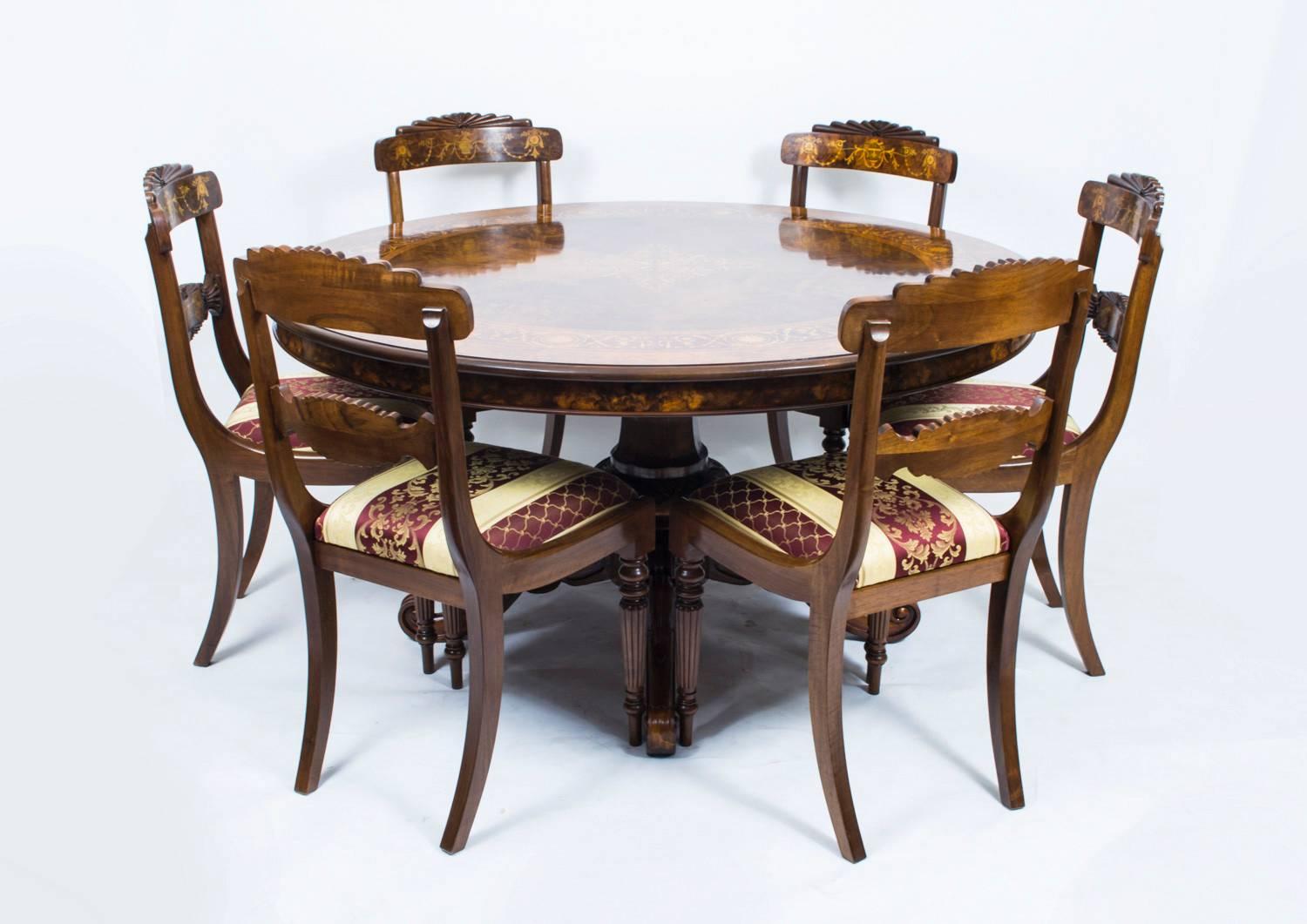 This is a stunning English marquetry centre table in fabulous Victorian style. 

The top is made from beautiful burr walnut with wonderful decoration of intricate hand cut marquetry with kingwood crossbanding. 

The four legged centre base means