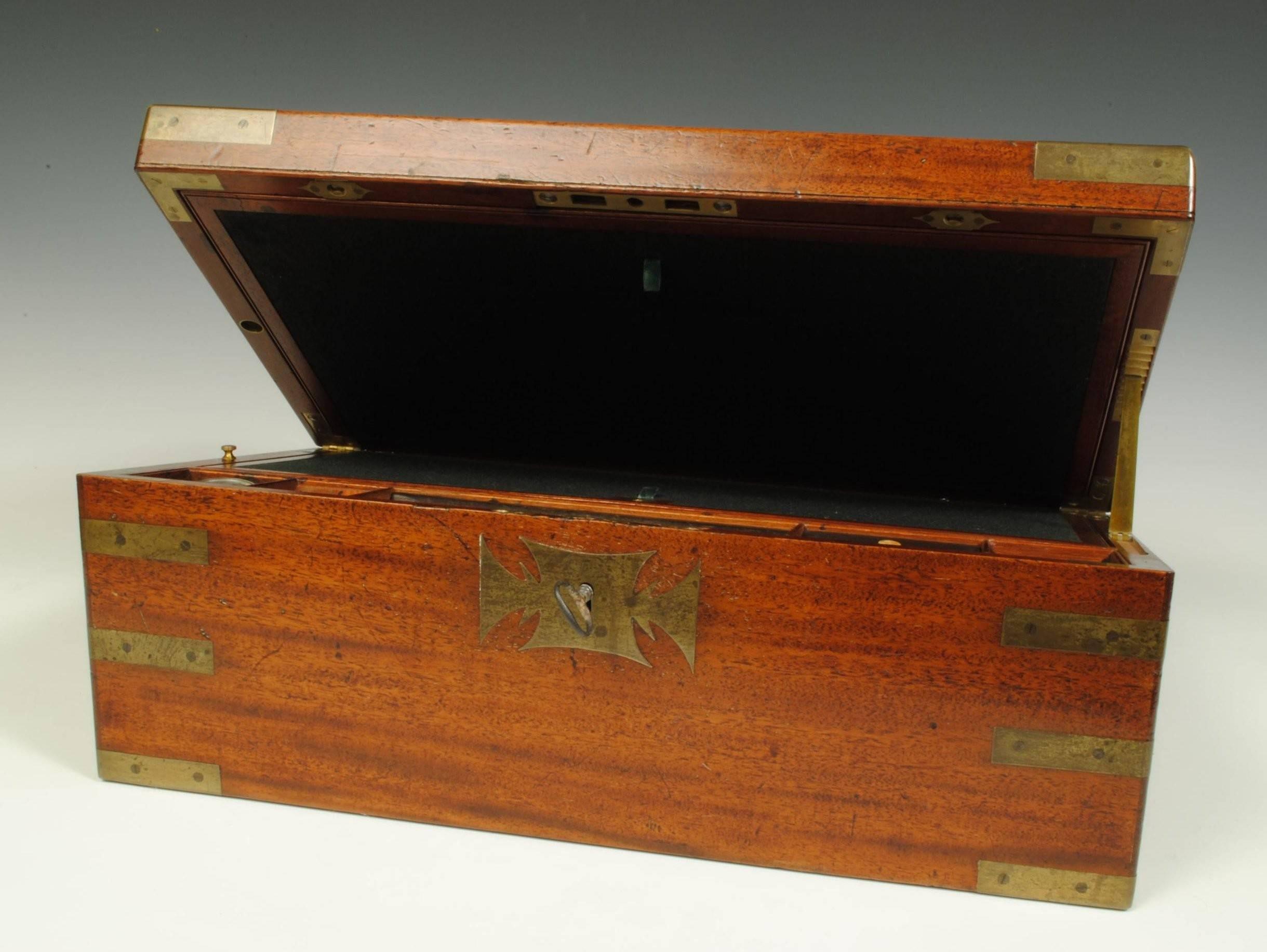 A superb quality 19th century mahogany and brass bound writing box with fine brass mounts, opening to reveal a slope with inkwells and hidden drawers.