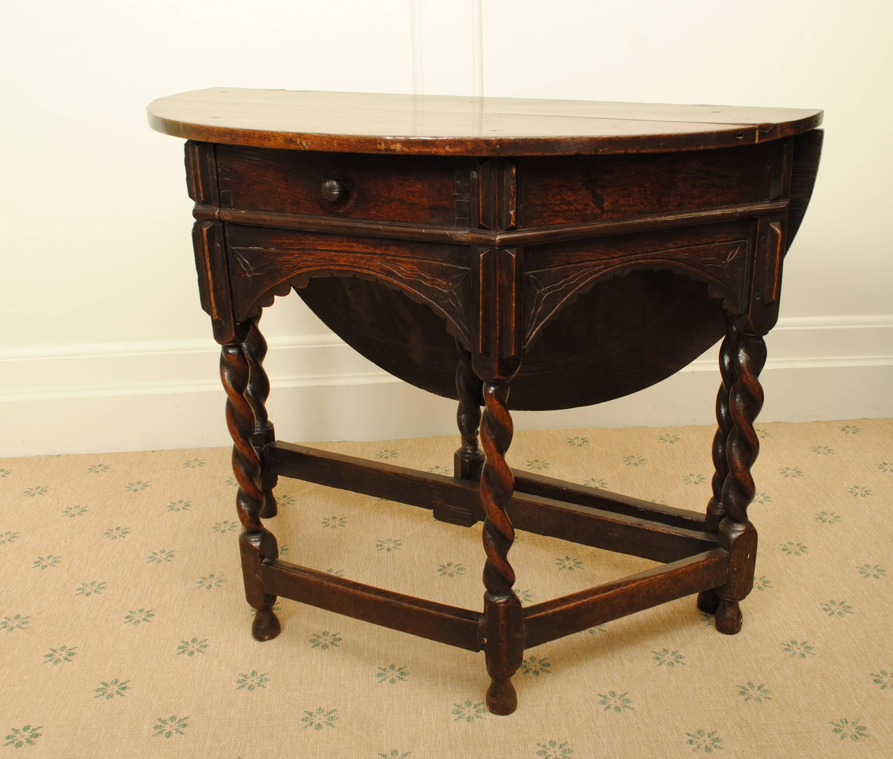 A 17th century oak credence table of good colour.