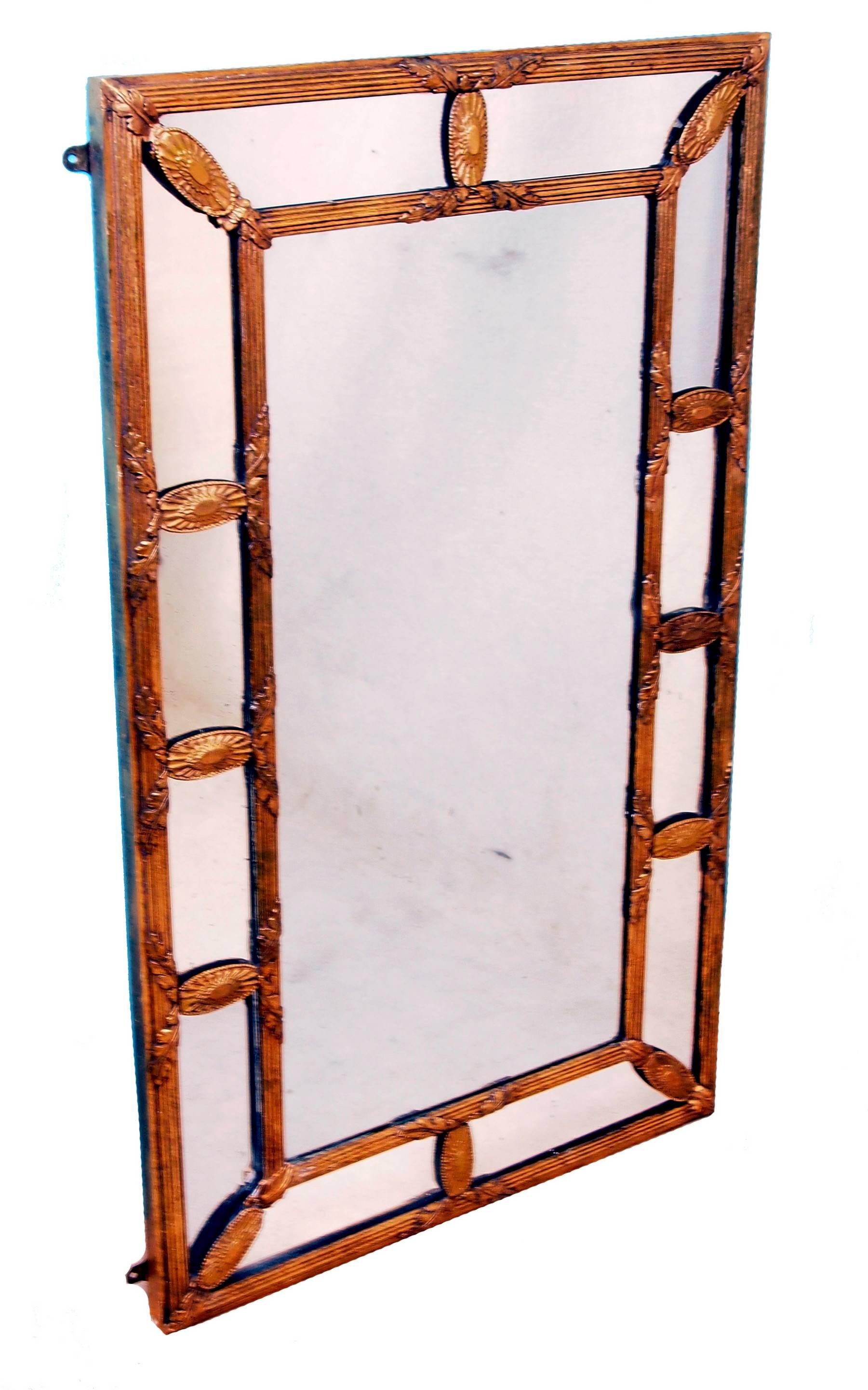 A very attractive early 20th century rectangular gilt overmantel mirror of section design having well carved and moulded decoration to frame.