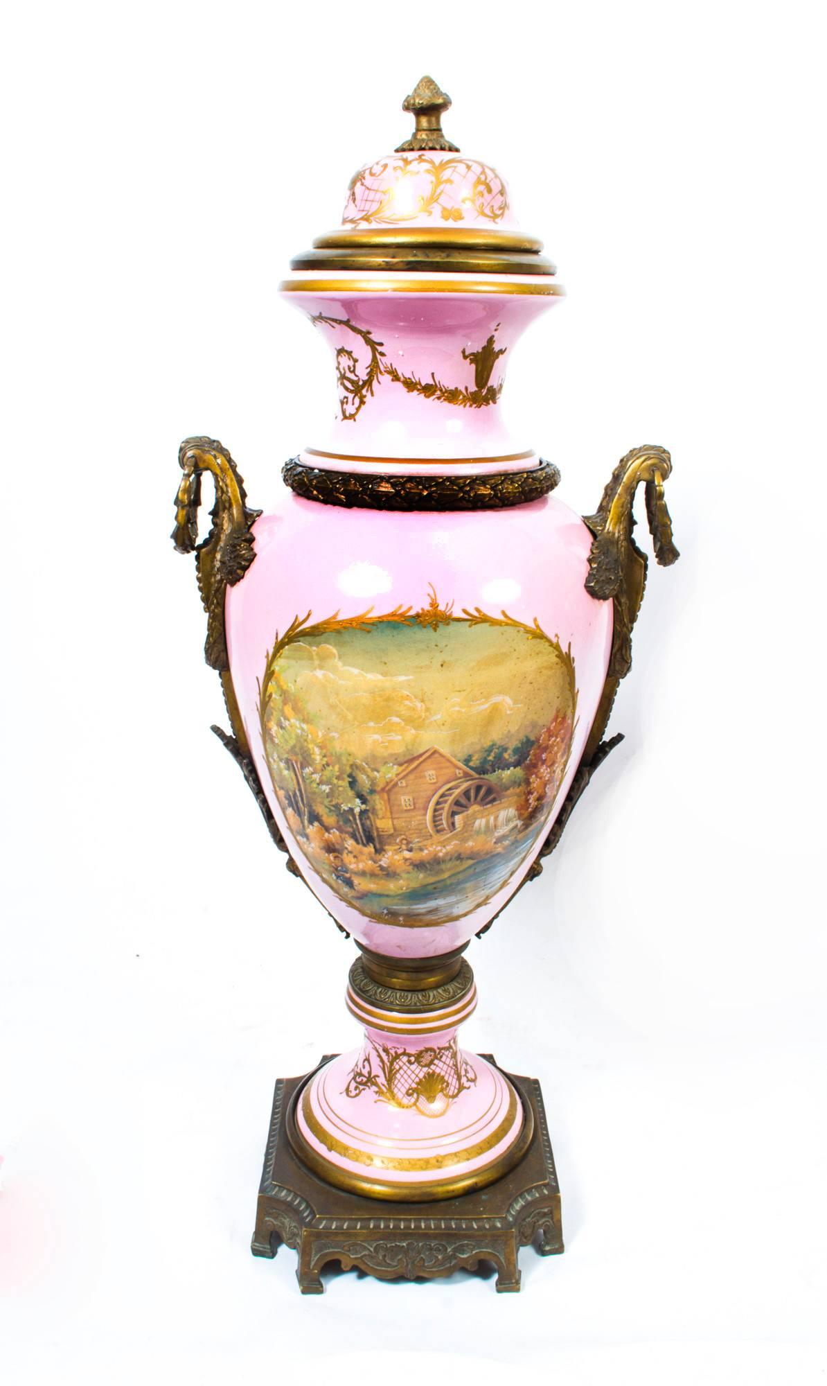 This is a large and stunning pair of Sevres style hand painted porcelain vases with fabulous ormolu mounts. 

The vases are a beautiful ‘rose pink’ in colour and have fabulous hand painted decoration as well as striking gilded highlights.