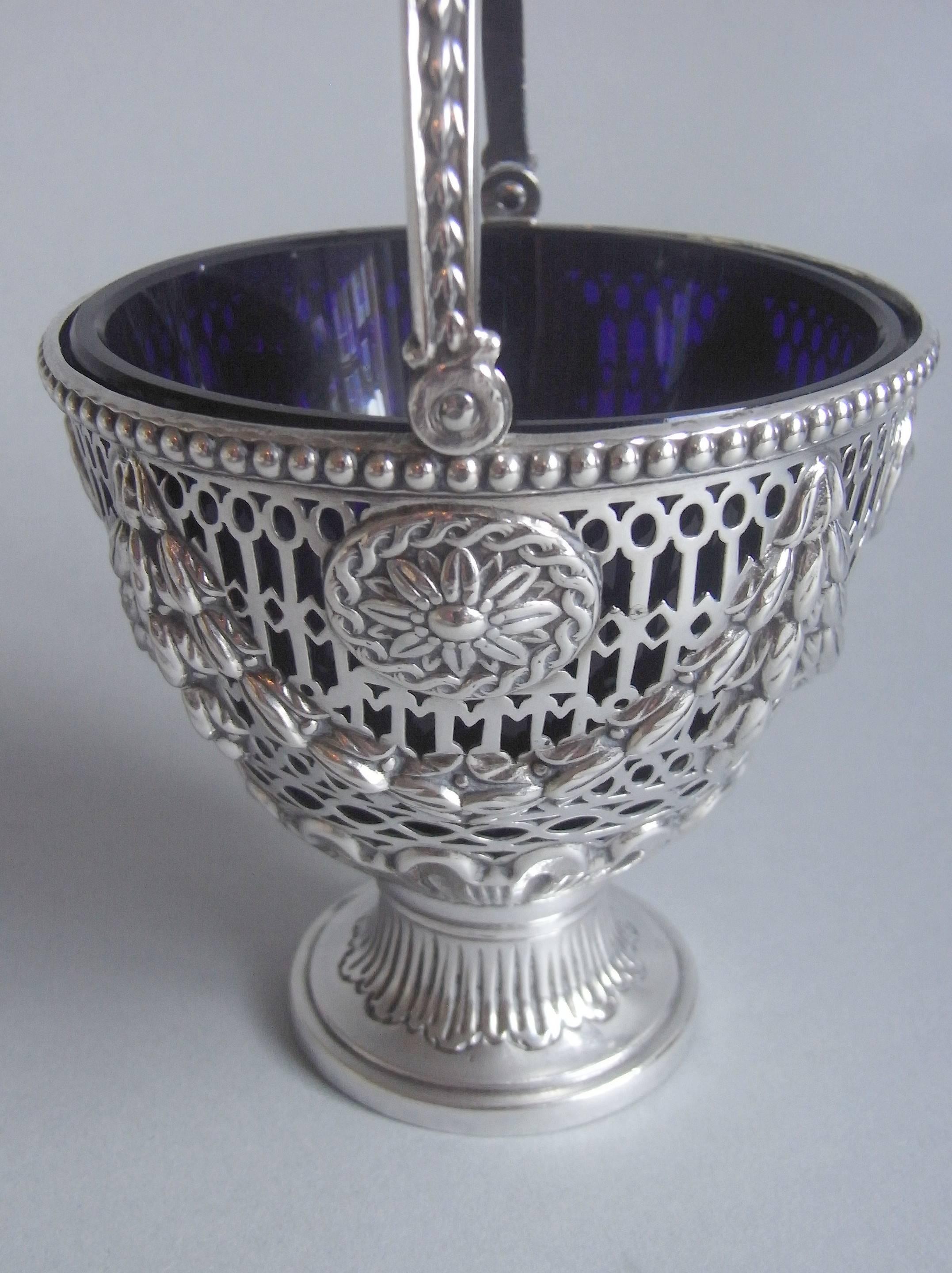 This very fine Pail stands on an unusual fluted circular pedestal foot. The main body displays a beaded rim and is pierced with different Neo-Gothic designs. The piercing is also decorated with neoclassical blue bell swags and unusual oval paterae