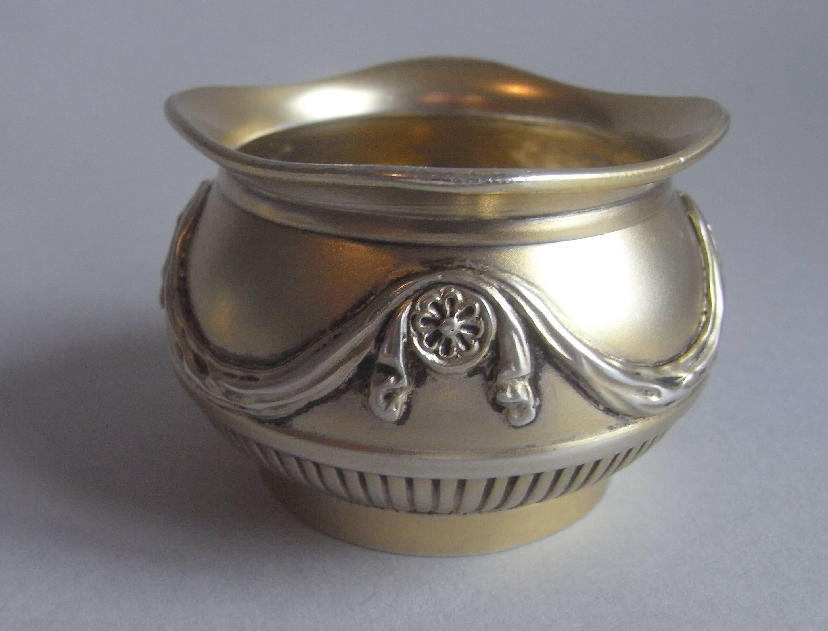The salt cellars are of a most unusual design and have a baluster form with everted dipping rim. The sides are decorated with a lower lobed band and the upper section is decorated with Classical drapery swags interspersed with paterae. Each is in
