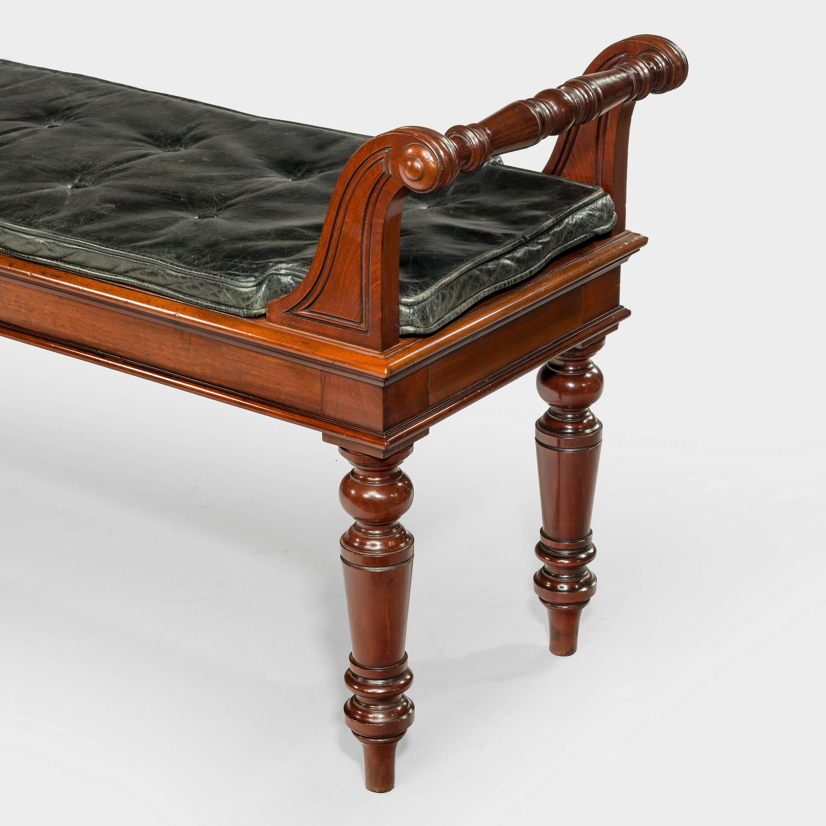 A late 19th century large Victorian mahogany hall bench. 
With a buttoned black leather cushion.