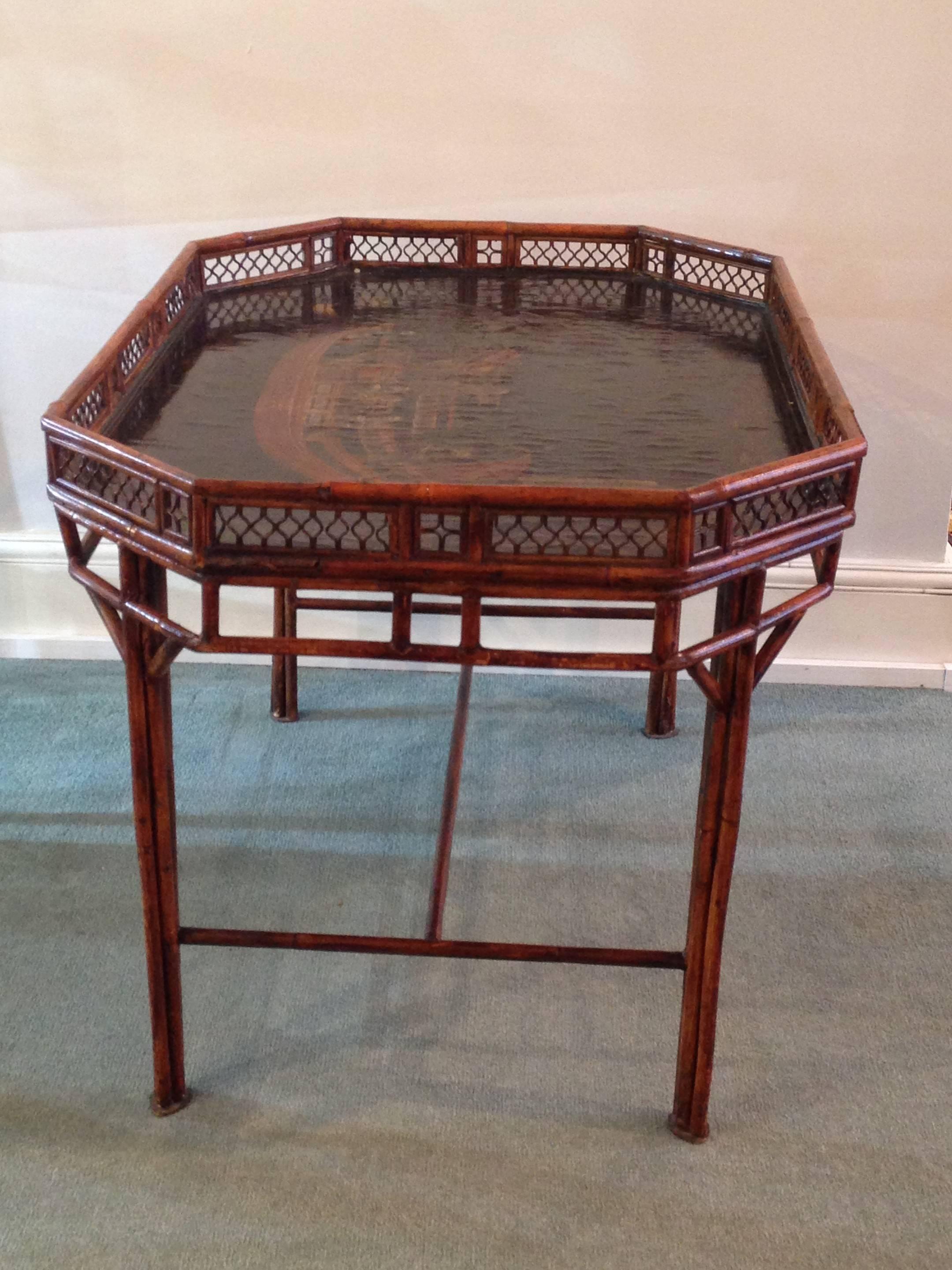 Early 19th century rectangular Chinese - Export black and gilt lacquered bamboo edged tray on a later modern metal stand in simulated bamboo, cluster columns legs. The fixed tray has a central scene depicting numerous guards and attendants aboard a