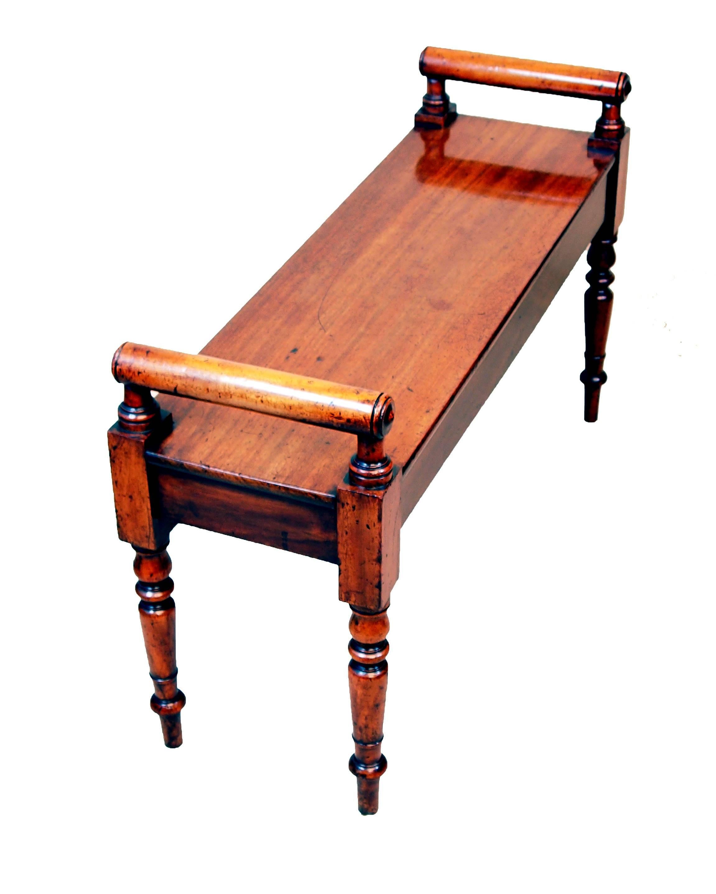 A good quality mid-19th century mahogany hall bench, or window
seat having well figured top with elegant raised turned rolls to
each end standing on fine turned tapering legs.
