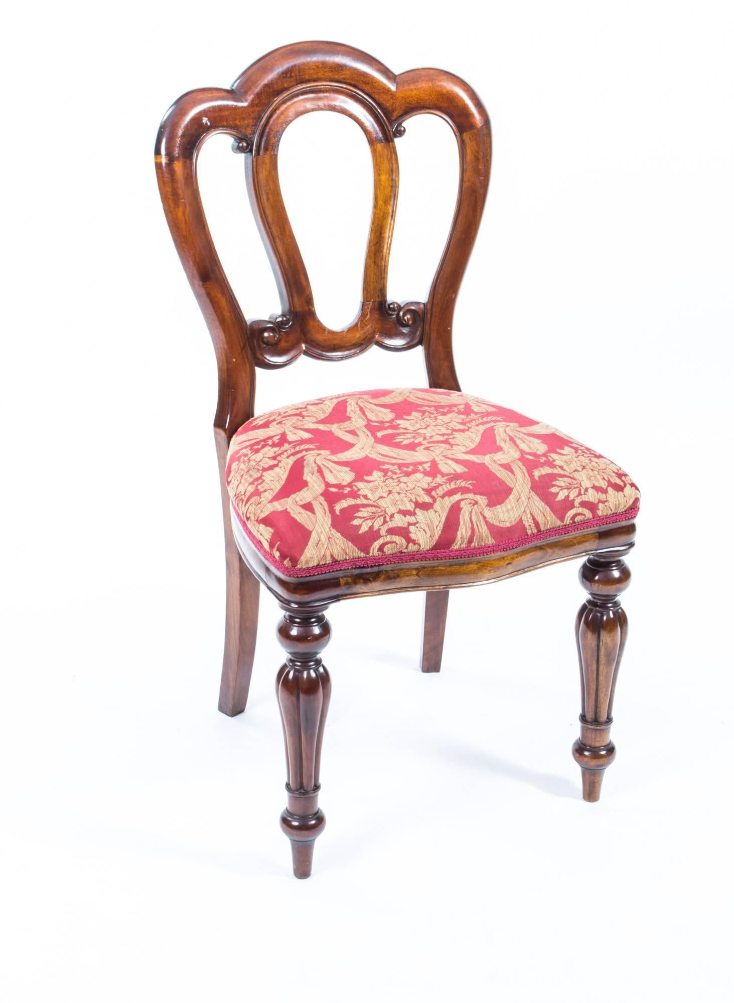 This is an elegant set of ten Vintage Victorian style admiralty back solid mahogany dining chairs dating from the second half of the 20th century. 

The chairs have a fabulous shaped top rail above a shaped open and carved back support. The