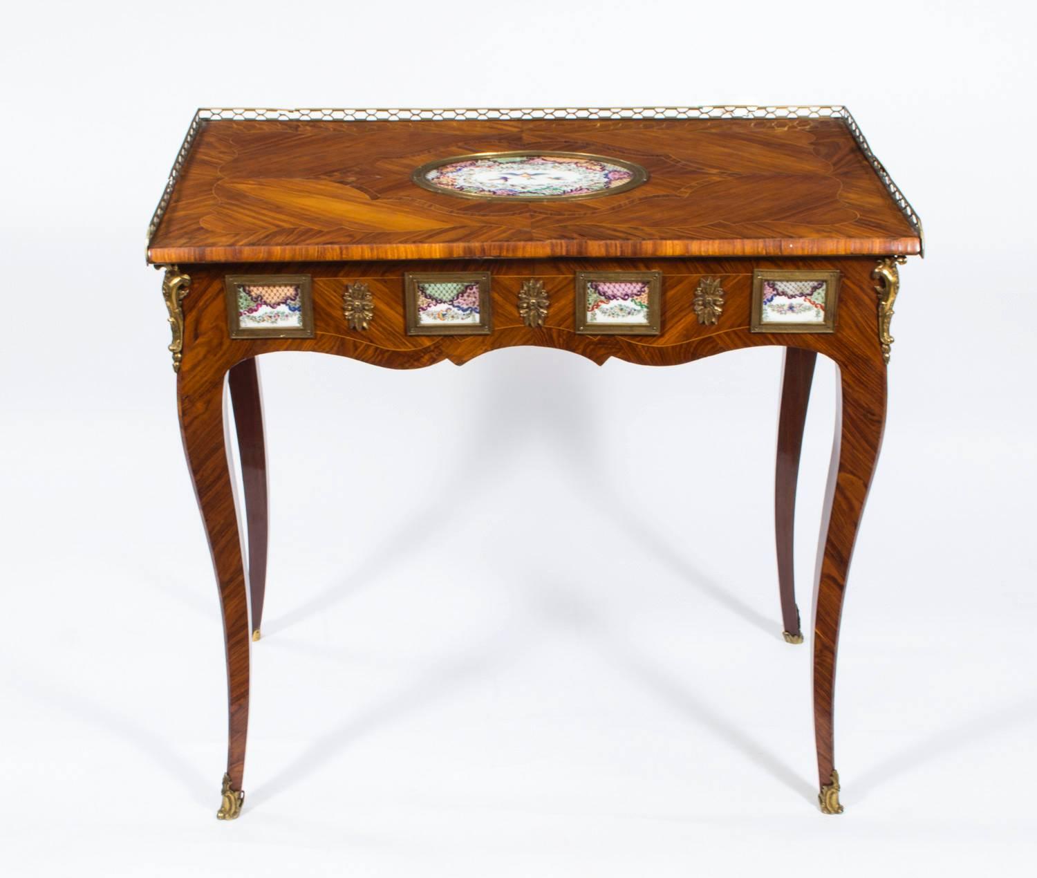 This amazing piece is an antique French writing table or side table with porcelain plaques and which dates from around 1780.

This late 18th century antique French walnut writing table (or side table) has been beautifully decorated with lovely