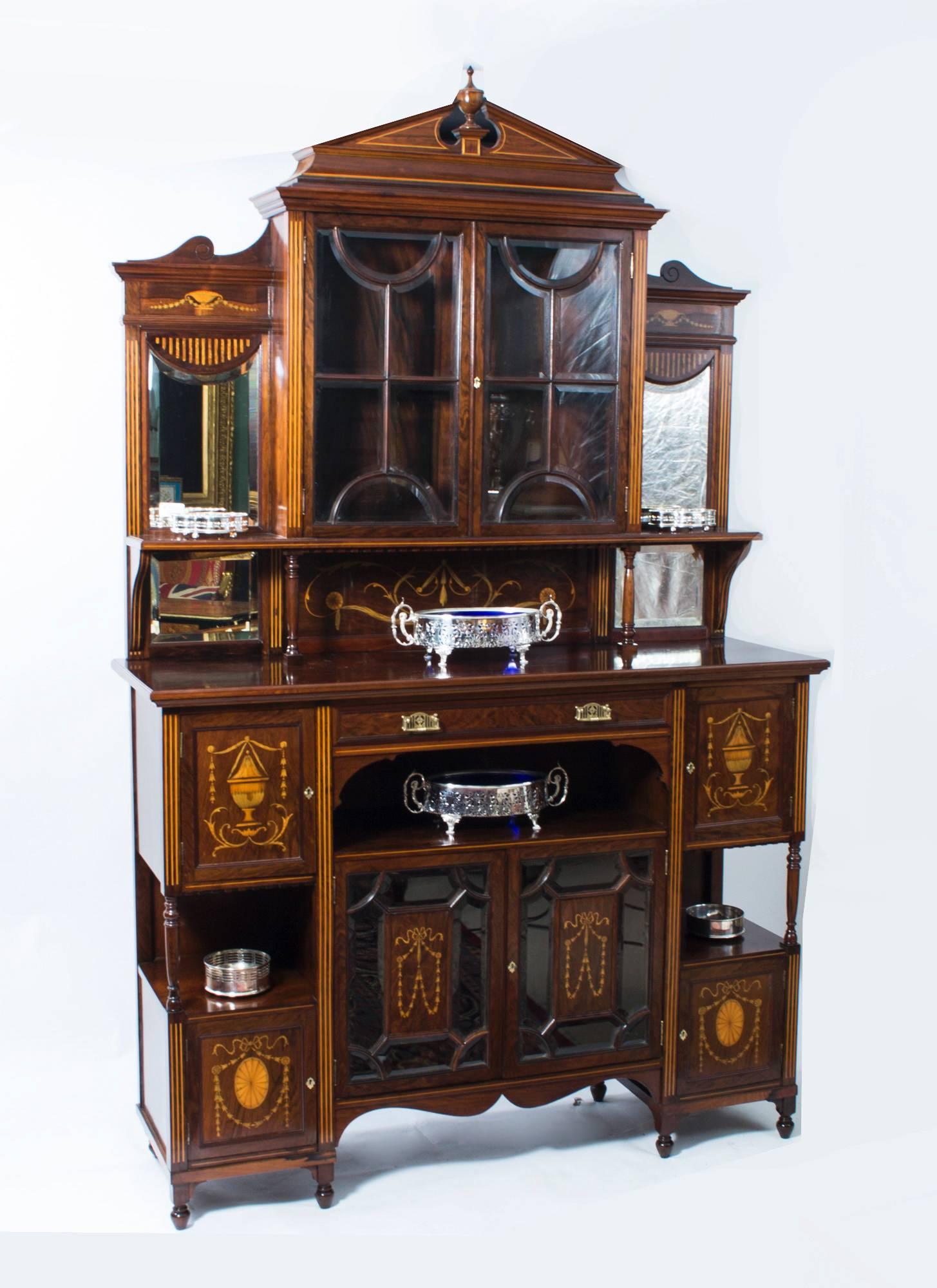 This is a stunning antique English Edwardian inlaid rosewood cabinet with mirror panels, circa 1890 in date. 

This cabinet is of the very highest quality, with exquisite hand cut inlaid satinwood marquetry decoration. 

The top has an elegant