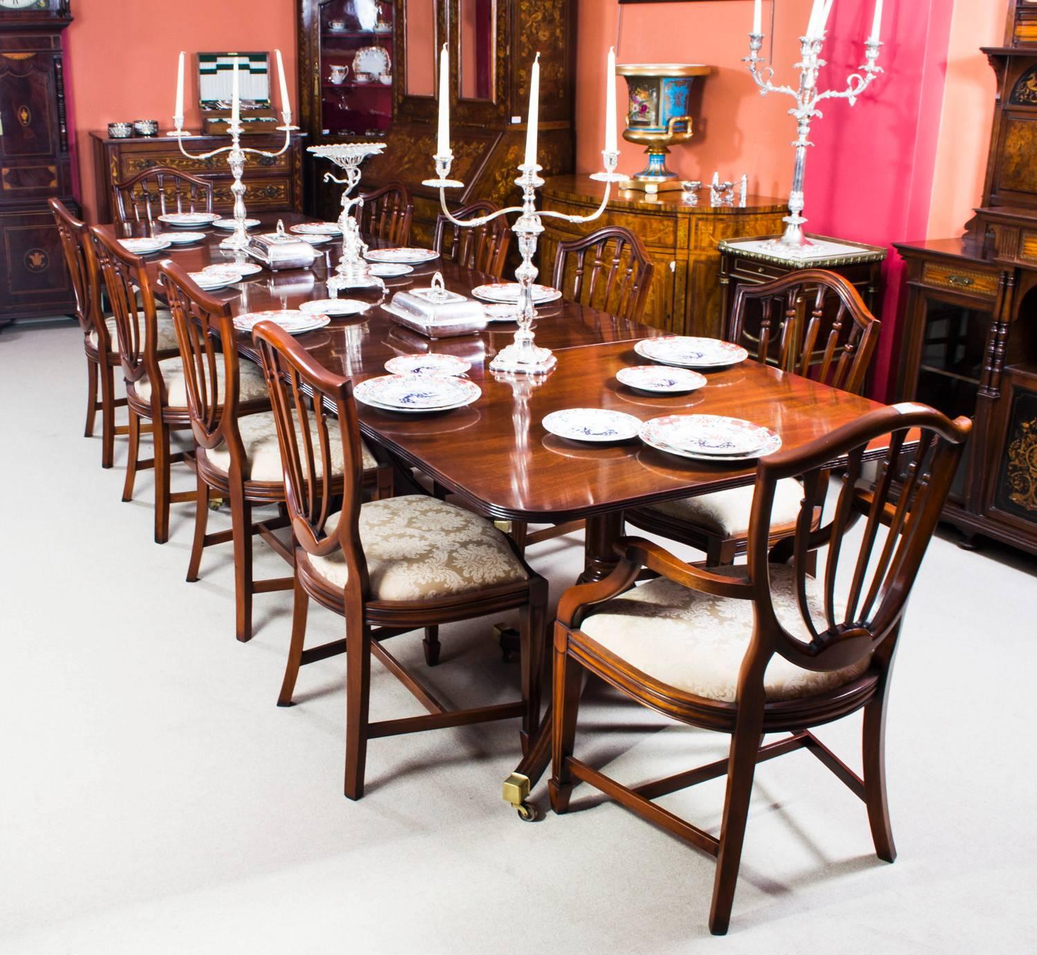 This is an elegant antique Regency style dining set that comprises an antique Regency style dining table, circa 1900 in date and the set of ten Hepplewhite style dining chairs. 

The table has two leaves which can be added or removed as required