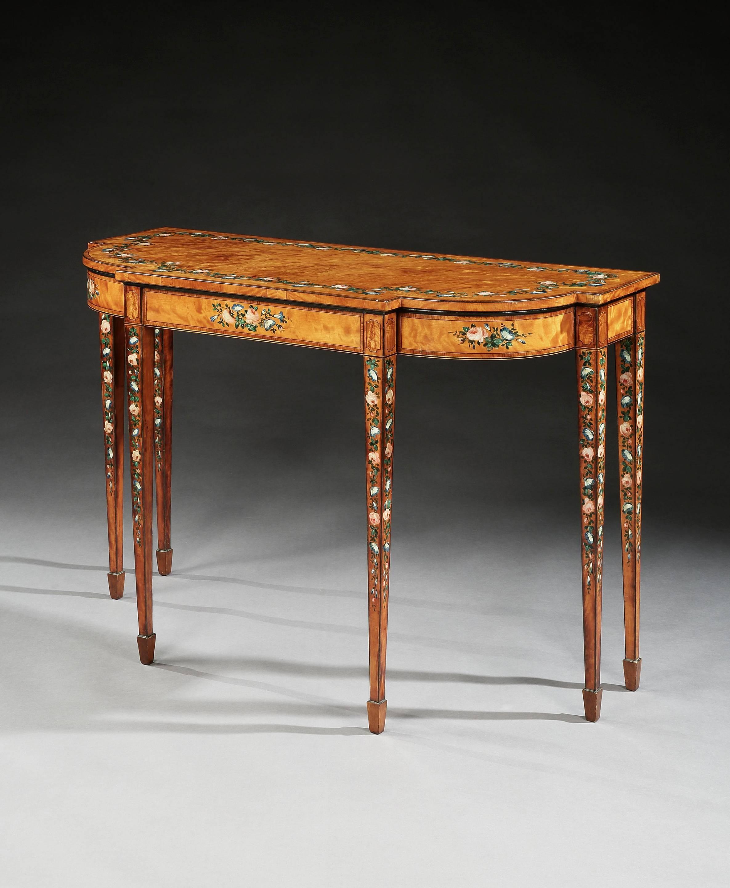 A rare George III Sheraton period satinwood console table, with kingwood crossbanding and painted floral decoration, the shaped top above a ebony-strung satinwood breakfront frieze, standing on square tapering legs with spade feet. The whole