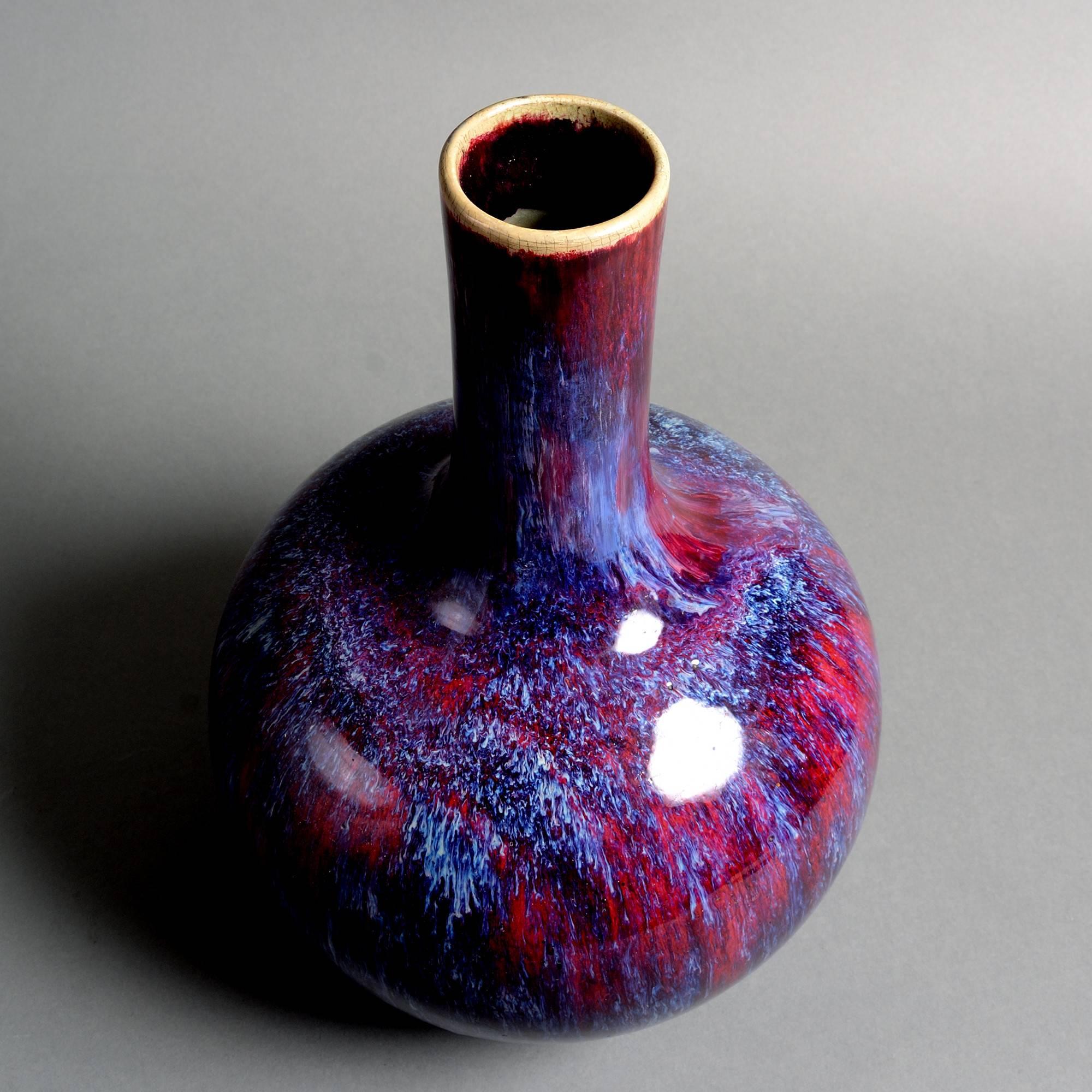 A 19th century bottle vase with rich sang de boeuf flambé glazes. 

Neck restored. 

P. 7.