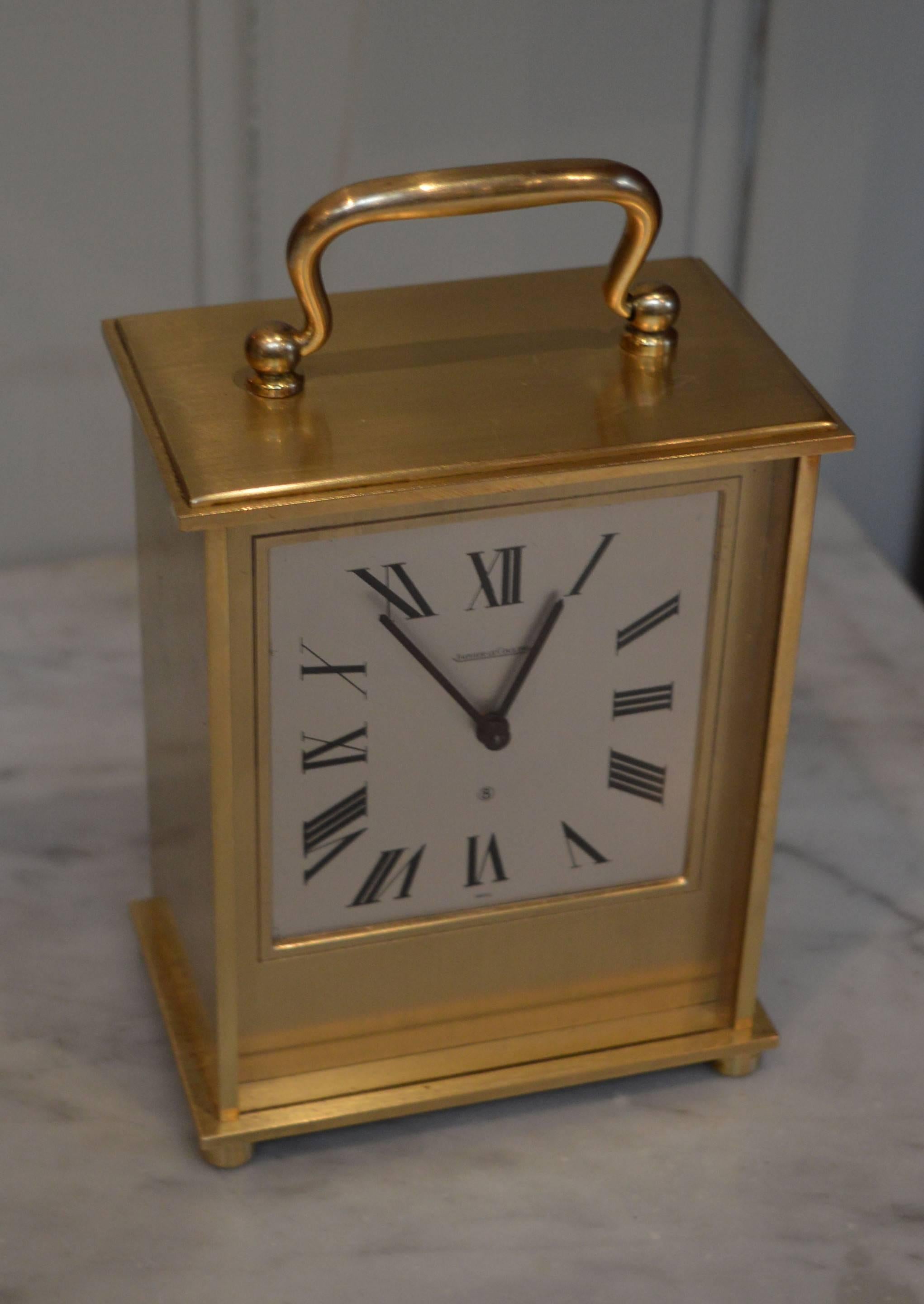 An 8 day, solid brushed brass carriage clock by Jaeger-LeCoultre. It has an 8 day movement that sounds the hours on a large bell, mounted within the casing but surrounding the movement.