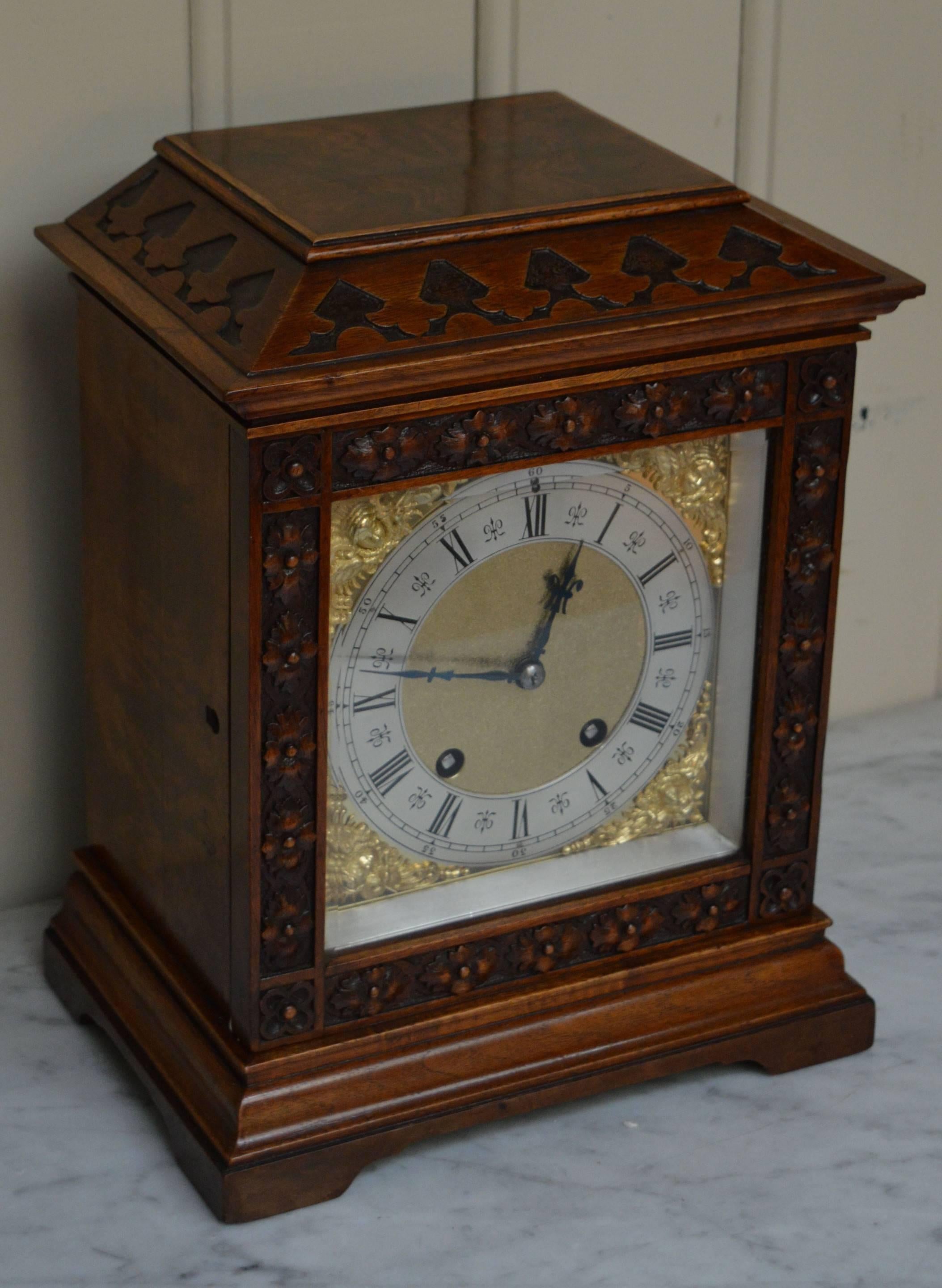 A nicely proportioned walnut ting tang bracket clock. It has a solid carved walnut and matched walnut veneer case, in the style of a late 17th Century bracket clock. It has a angled top, a carved door with a thick bevel edge glass and a stepped