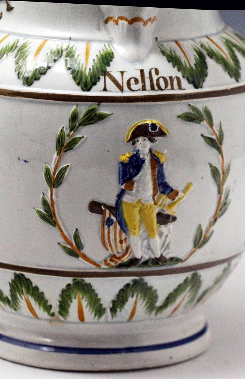 A fine and rare prattware pottery commemorative relief moulded pitcher celebrating Nelson and Britannia. 
The relief moulded cartouches of Nelson, a ship under sale, Britanni flanked by military men are spectacular with crisp and good detail. There
