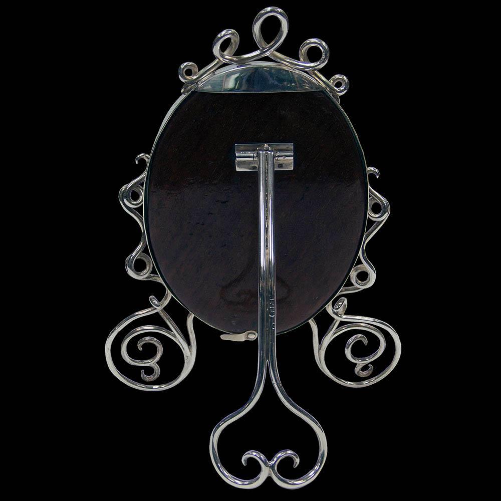 An interesting Victorian oval photograph frame with wire-work feet and decoration. The wooden back supported by a wire-work strut.