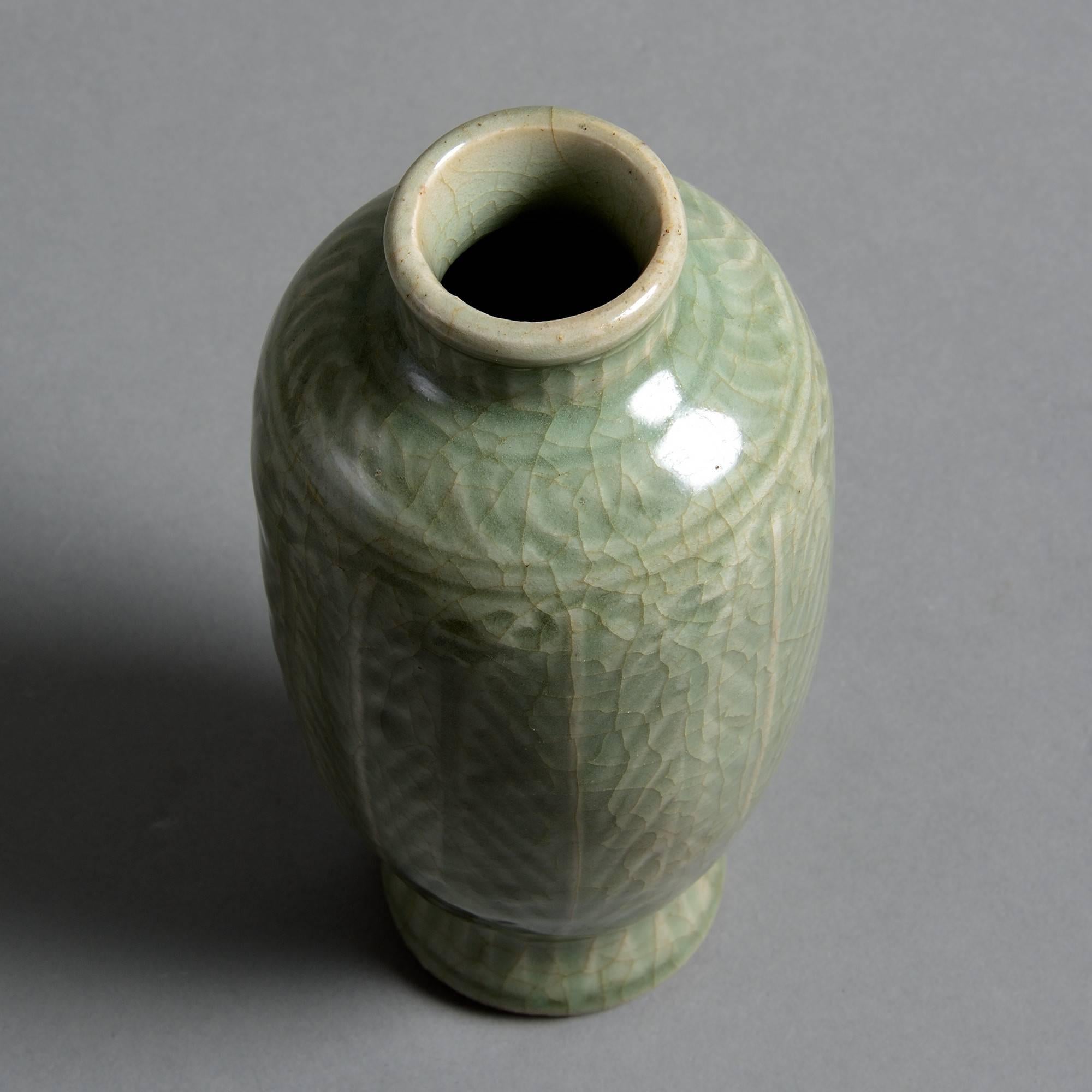 A late 16th century celadon porcelain vase, the body with palm decoration under a crackle glaze. 

Ming dynasty (1368-1644).