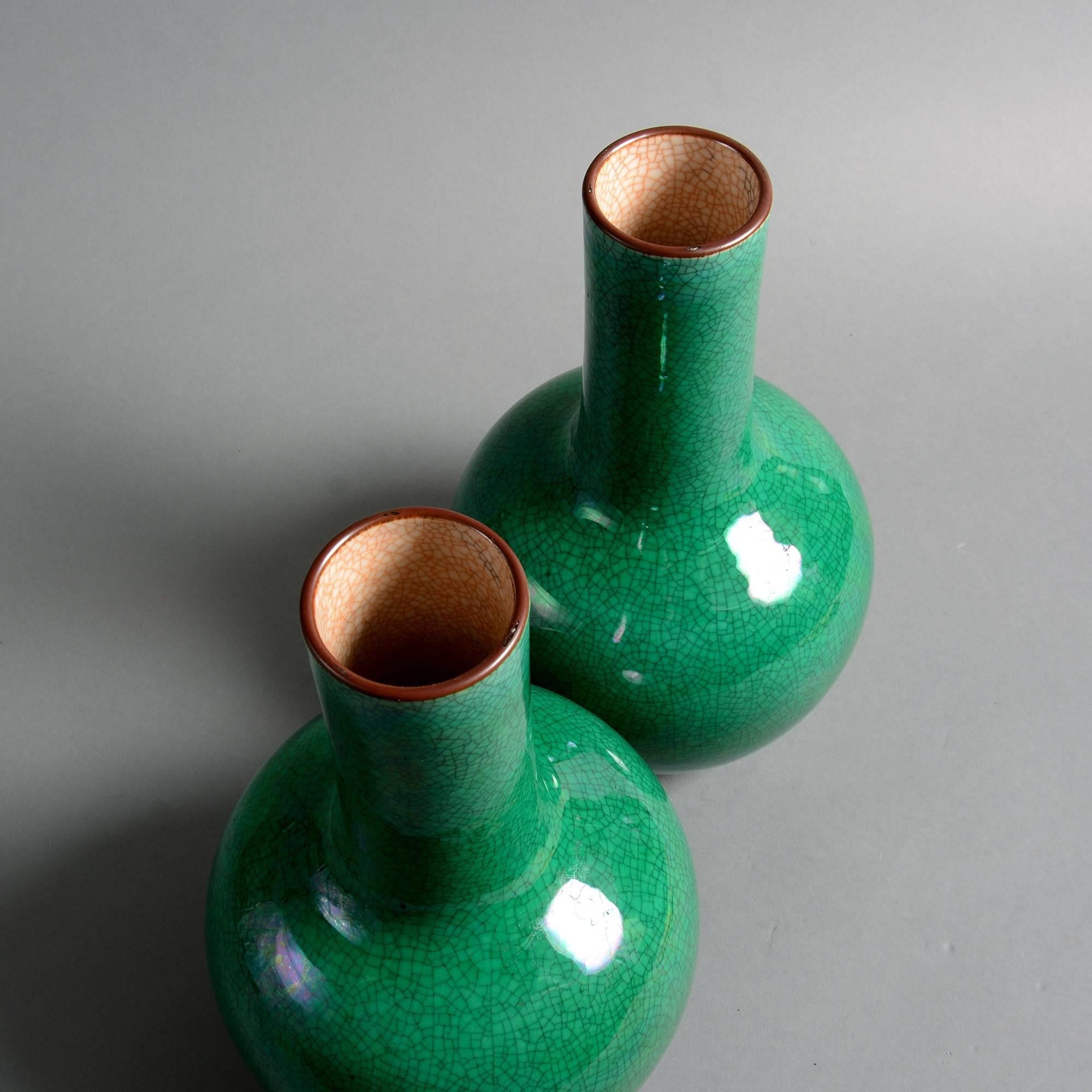 A pair of late 19th century porcelain bottle vases, with green crackle glazes. 

Qing dynasty, Guangxu period.