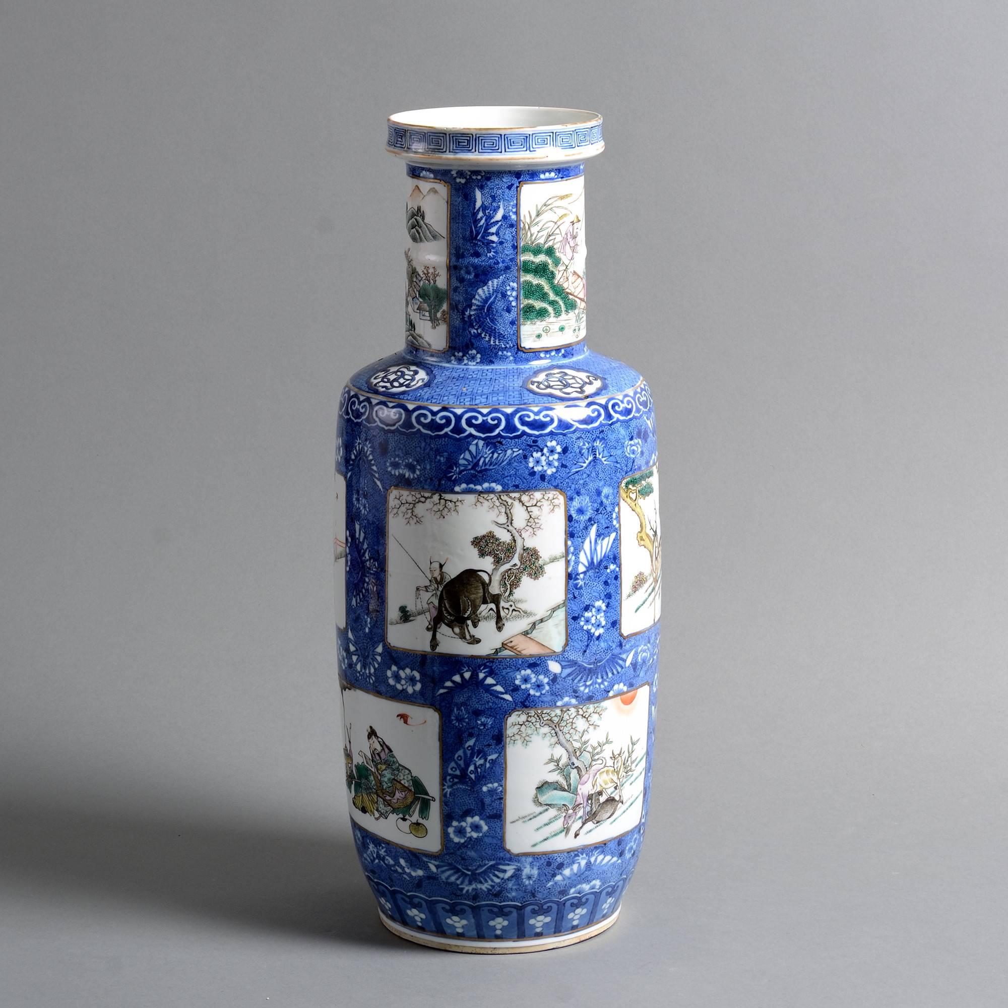 A 19th century famille verte porcelain rouleau vase, decorated throughout with figurative panels on an intricate blue ground.

Qing Dynasty, Xianfeng Period.

Condition: Good, with rim chip restored.