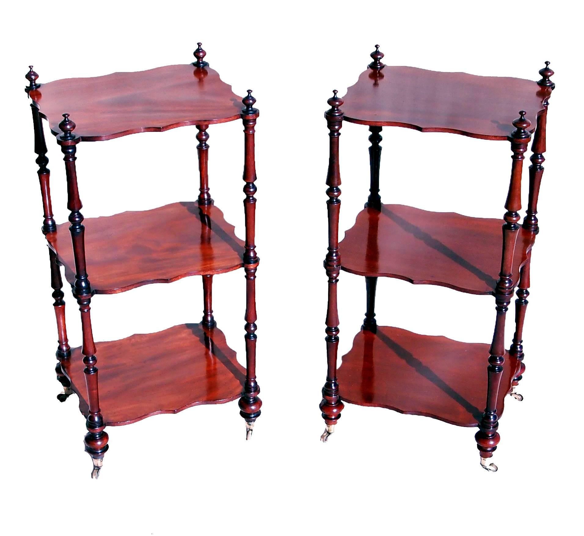 A very attractive mid-19th century mahogany pair of whatnots, or
Étagère’s each with three well figured shaped shelves raised on
Elegant turned upright supports

(An extremely useful size and elegant design this pair of whatnots are 
a very