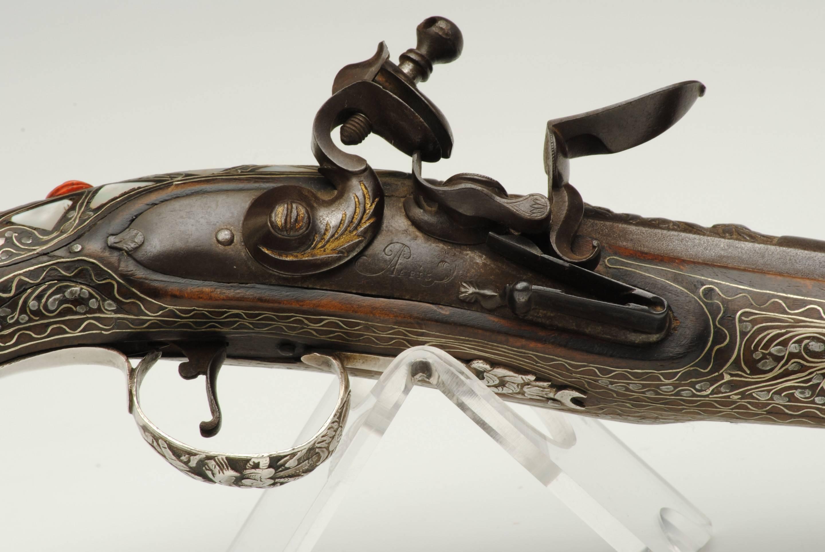 A good example of a french flintlock pistol made for the Turkish market, the lock signed Paris. 
The walnut stock beautifully inlaid with diver wire, mother of pearl and red coral. The cannon barrel also decorated.