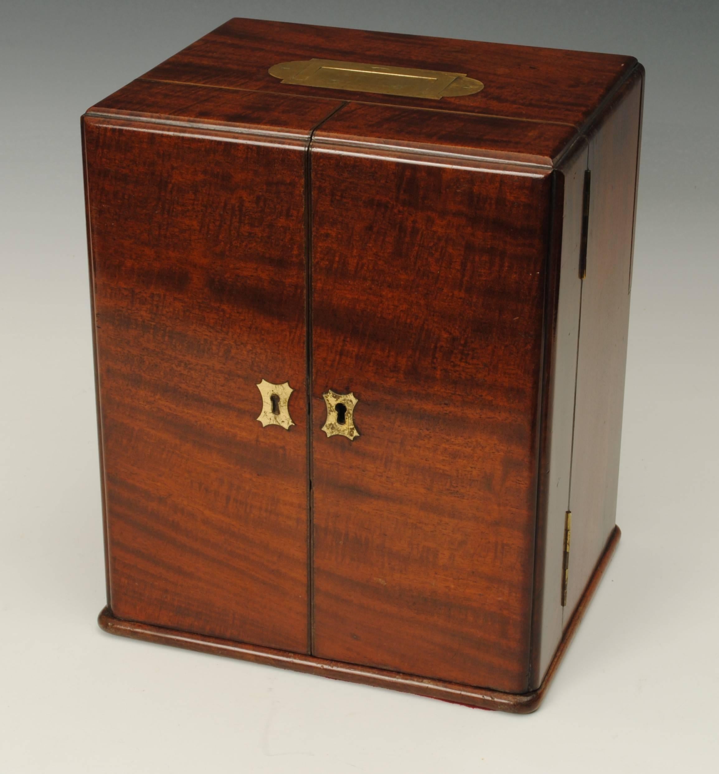 A good example of a mahogany cased apothecaries box with bottles and scale the back with a hidden panel.