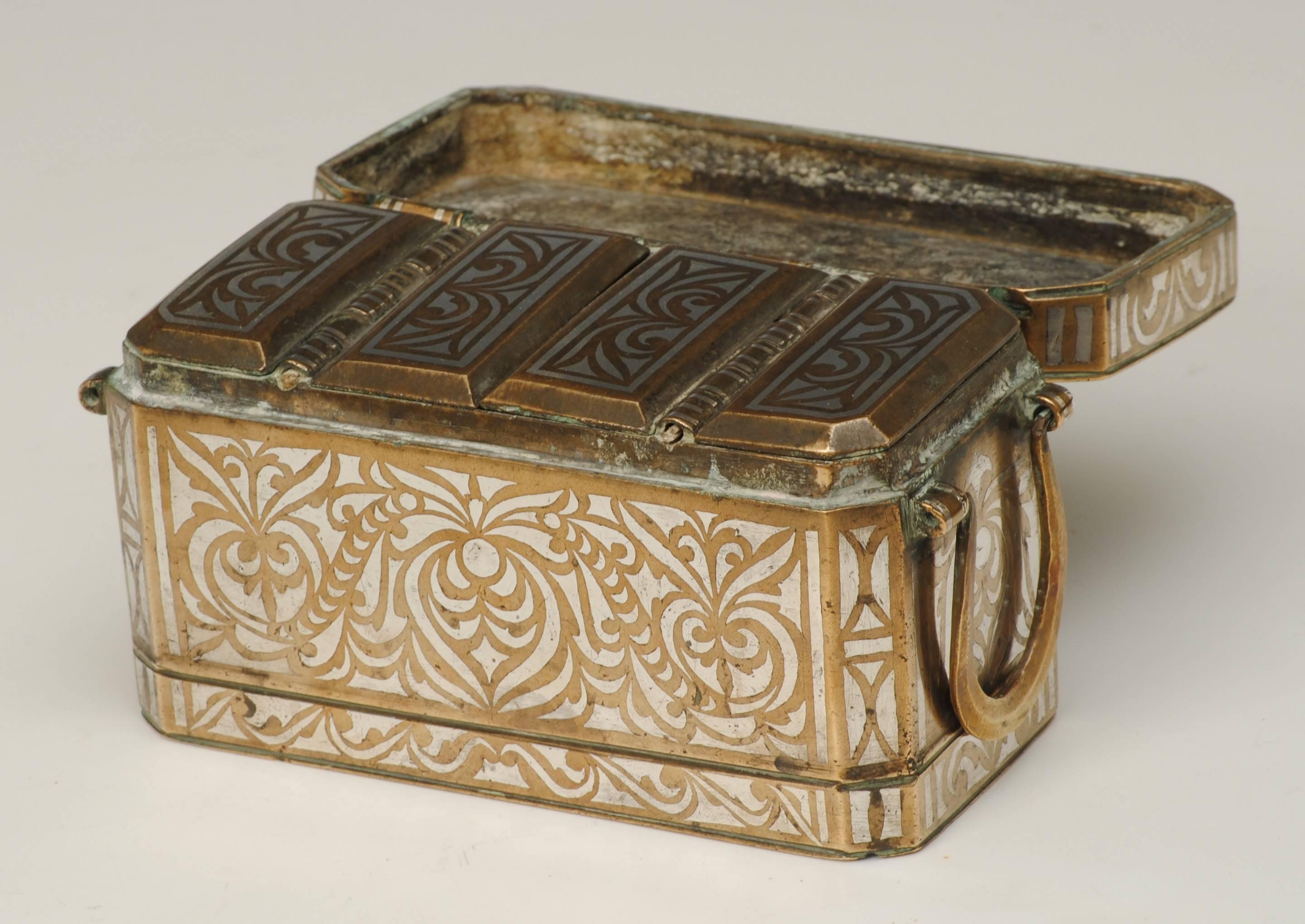 A good example of a betel nut box with silver inlay and four lidded compartments.