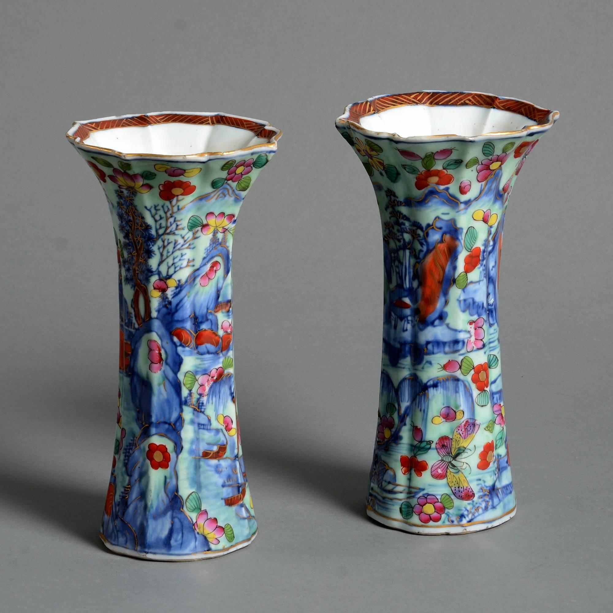 A fine pair of late 18th century porcelain trumpet vases with clobbered decoration throughout. 

Qing dynasty, Qianlong period.