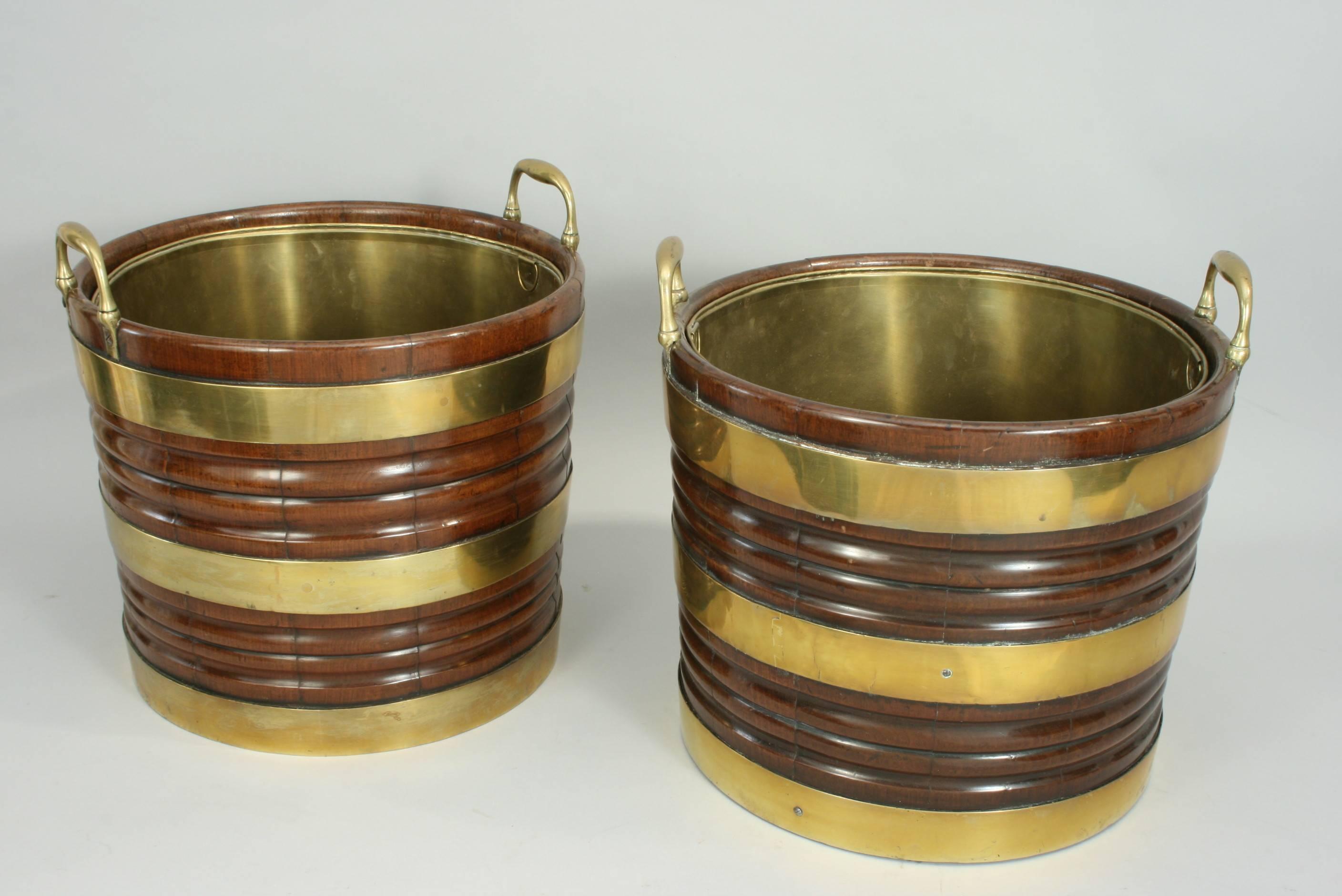 Irish mahogany peat buckets.
A very rare pair of good quality brass-bound mahogany peat buckets in original color and good patina. Each bucket is of a coopered construction with ribbed bodies, a slightly tapering circular shape, three brass bands,