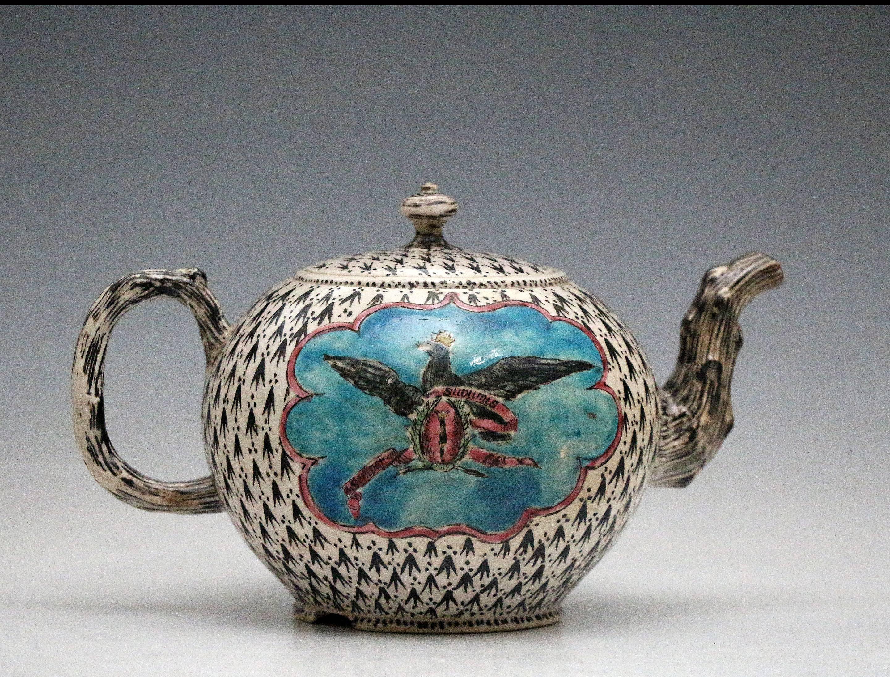 Fine King of Prussia saltglaze teapot, Staffordshire, mid-18th century. The teapot is a globular form, applied with a crabstock handle and spout, fully decorated with an 'ermine' ground of darts and dots in black, reserved with a colorful