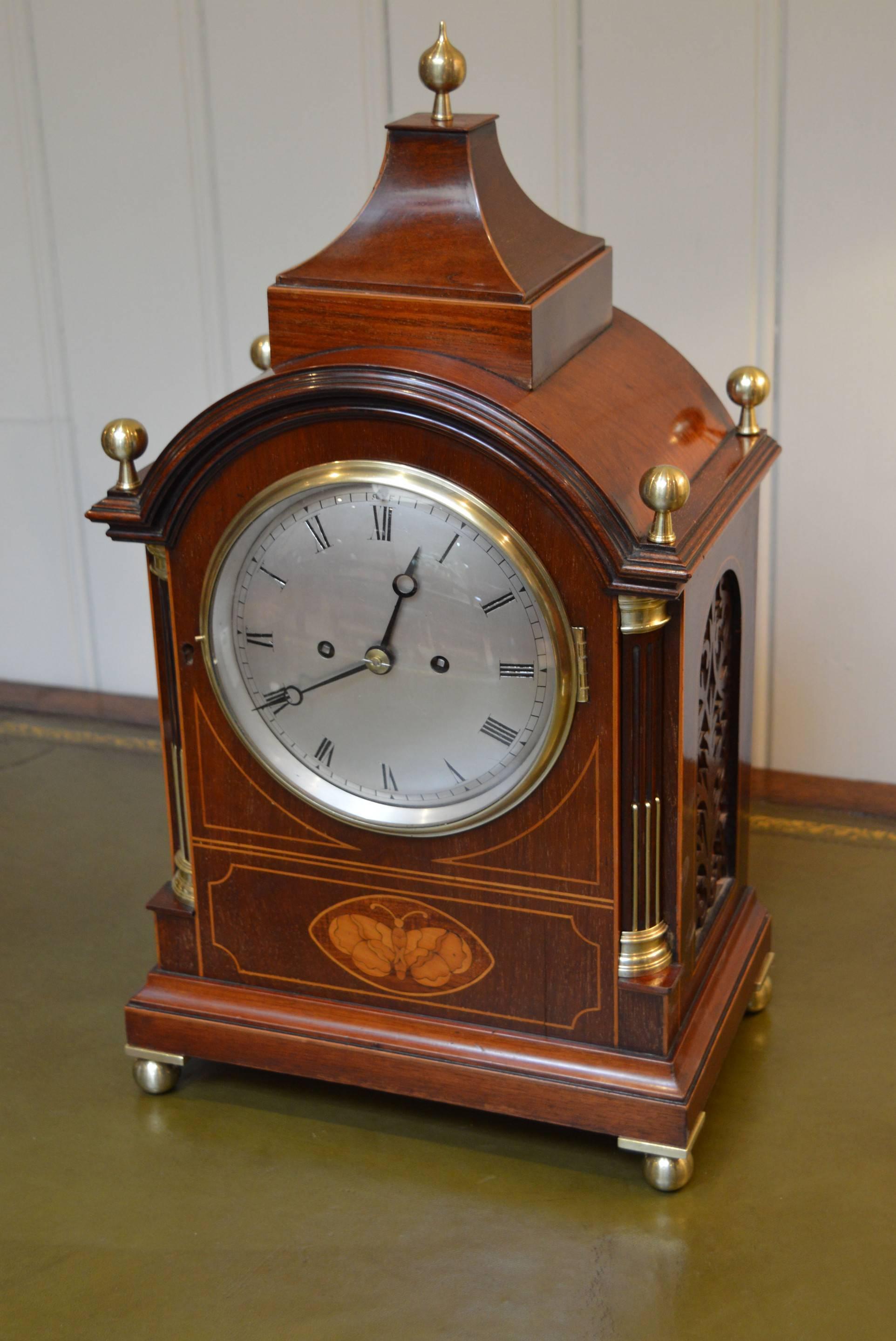 A substantial, good quality, classical English bracket clock dating to the end of the 19th century. It has a pagoda top with a brass finial, mounted on a break arch case, with quartered corner pillars, all with boxwood stringing and a central