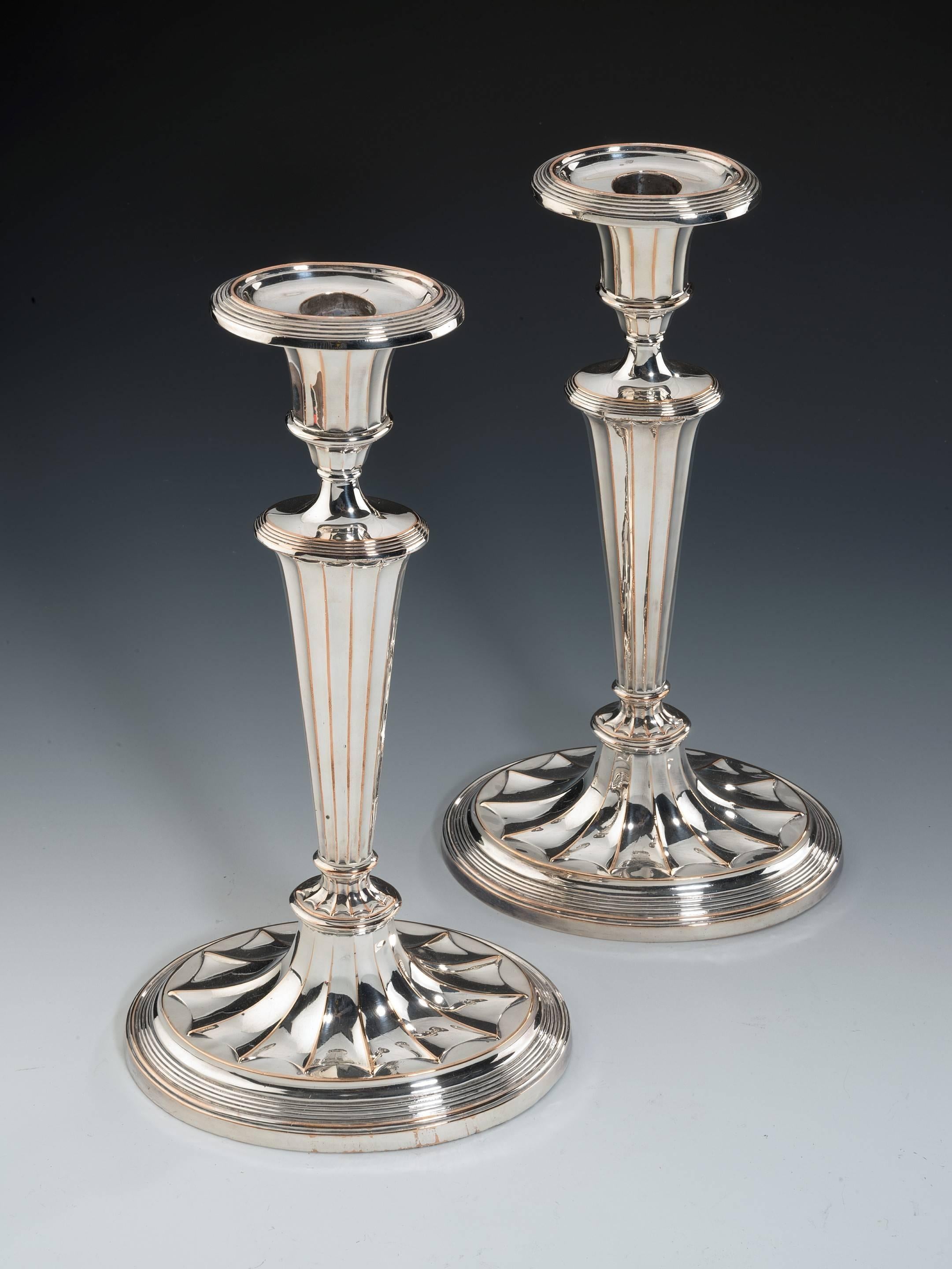 Old Sheffield oval based candlesticks by John Parsons & Co, George III period, circa 1785.