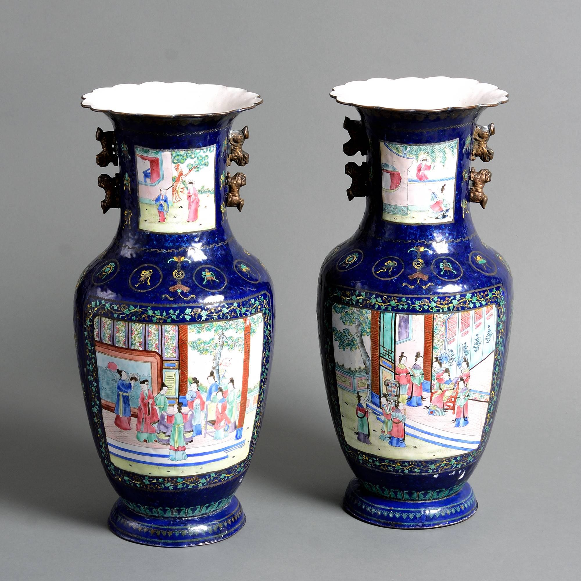 A fine pair of early 19th century Canton Enamel vases, each decorated with figurative polychrome panels upon rich blue ground. 

Qing dynasty.

Daoguang Period (1821-1850)

with restorations.