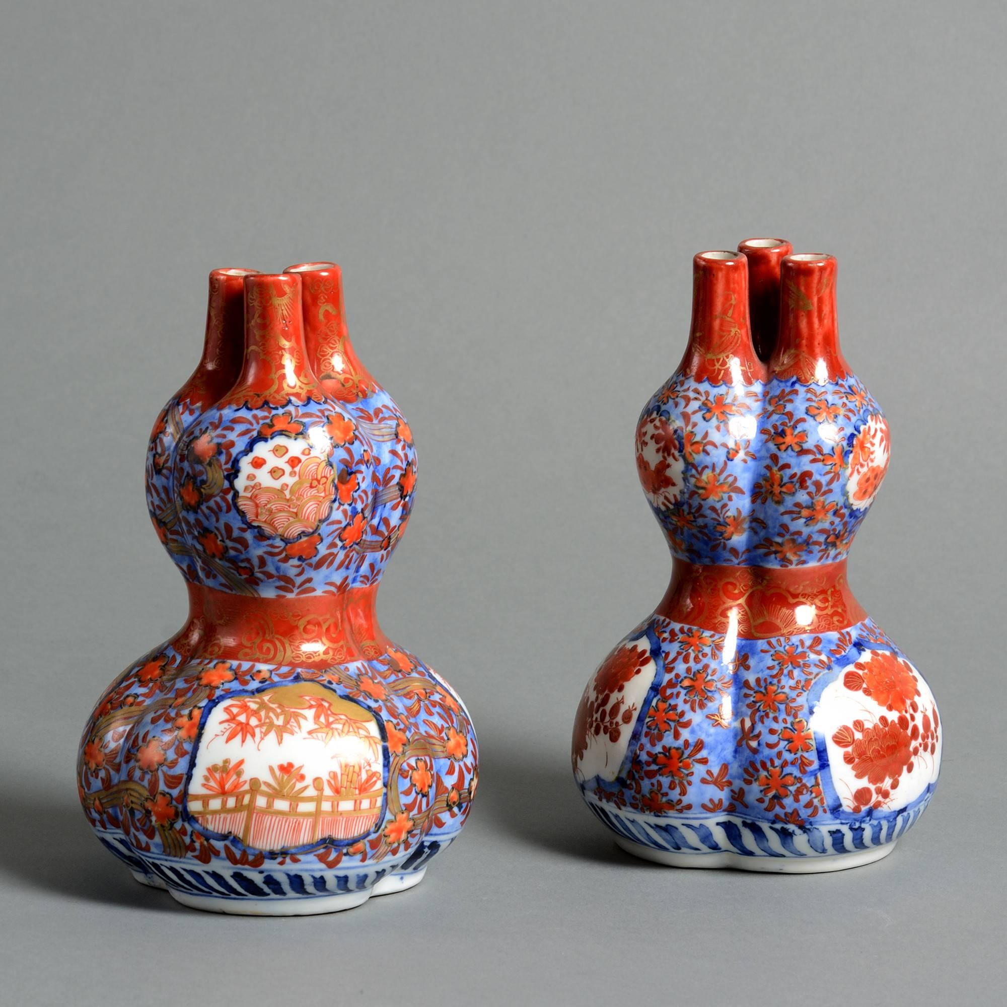 A pair of late 19th century triple gourd Imari vases, the bodies richly decorated in red, blue and gold glazes upon a white ground. 

Meiji Period (1867-1912).