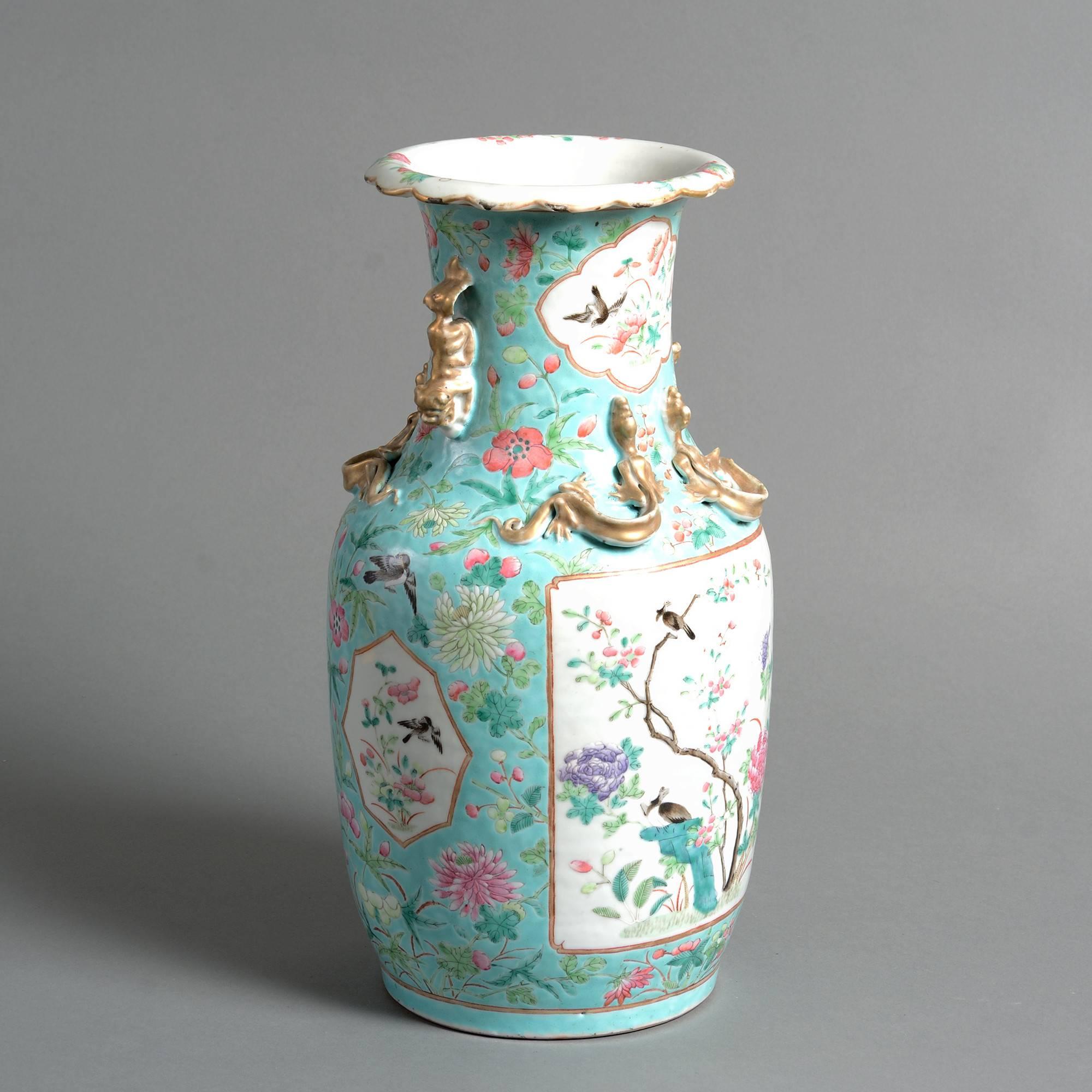 A fine late 19th century Canton porcelain vase with applied gilded handles and lizards, the body with ornithological and floral scenes in famille rose glazes upon a turquoise ground. 

Qing dynasty, Guangxu period (1875-1908).