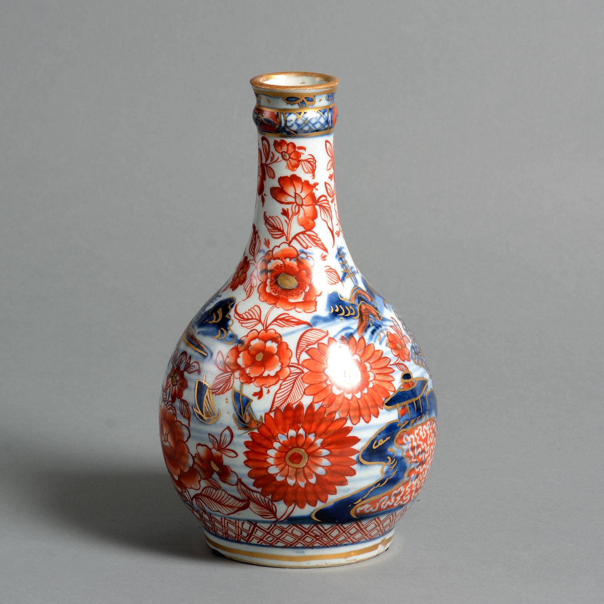 A late 18th century clobbered porcelain bottle vase, with floral decoration throughout. 

Qing dynasty, Jiaqing period (1796-1820).