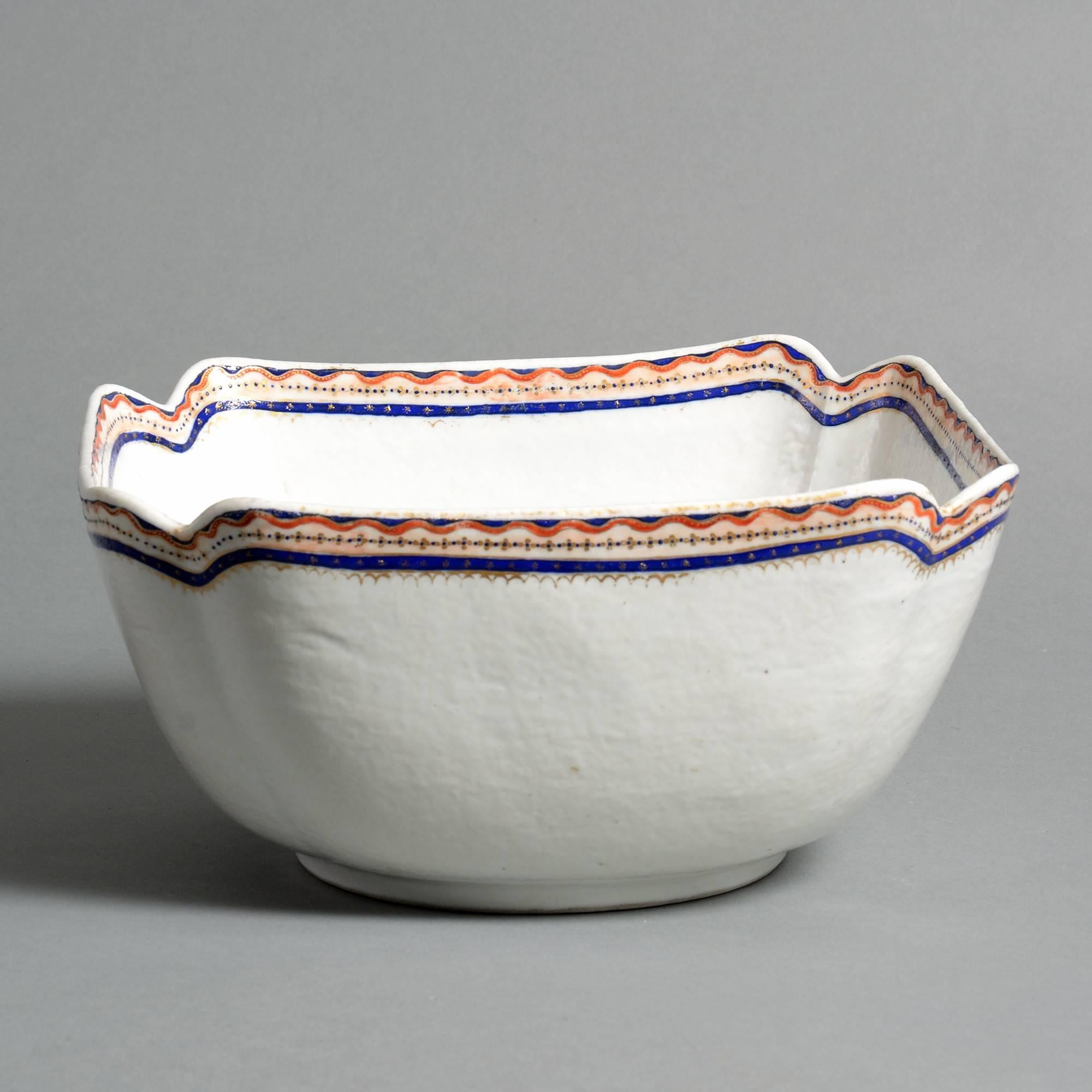 A late 18th century porcelain bowl, the body of square form, having re-entrant corners, the rim with red a blue glazes.

Qing dynasty, Qianlong period (1736-1820).
