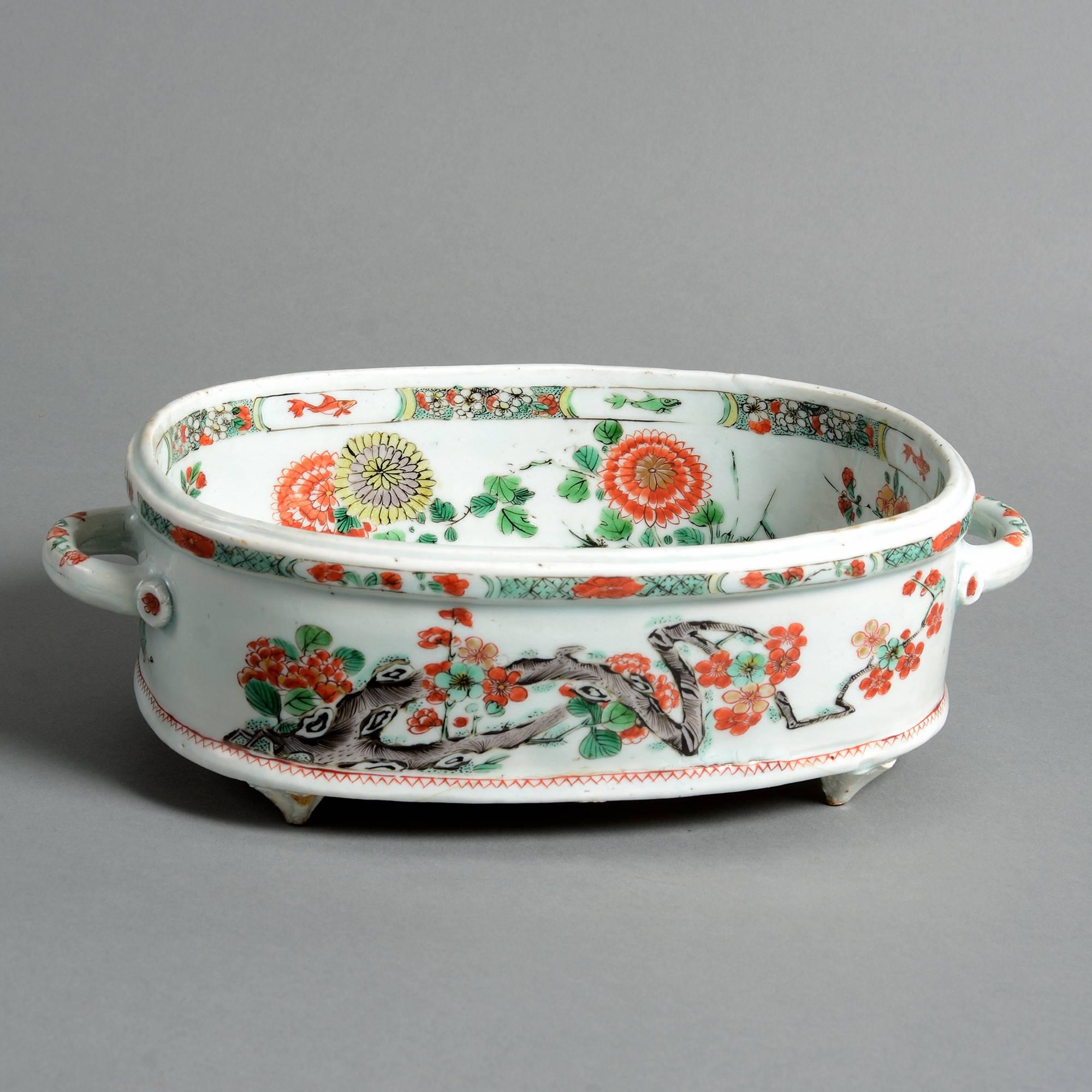 Two fine early 18th century famille verte porcelain jardinières of oval form, each decorated with stylized peonies on a white ground,

Qing dynasty,

Kangxi period (1661-1722).