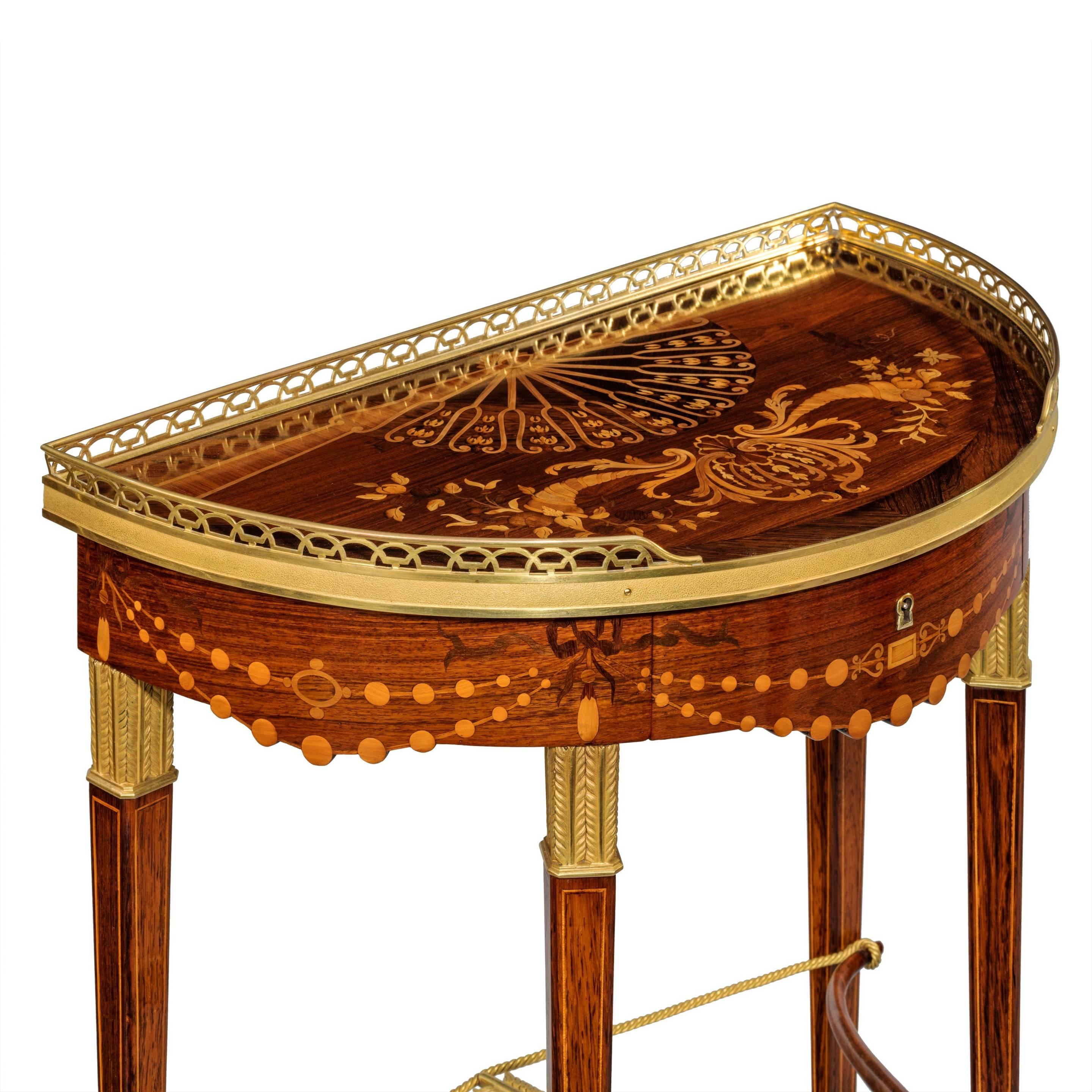 A companion pair of demilune bow and arrow tables by Alix, each freestanding table with an ormolu gallery and disguised frieze drawer, all raised on four stylized quivers joined by a drawn bow and ormolu arrow, inlaid throughout with a variety of