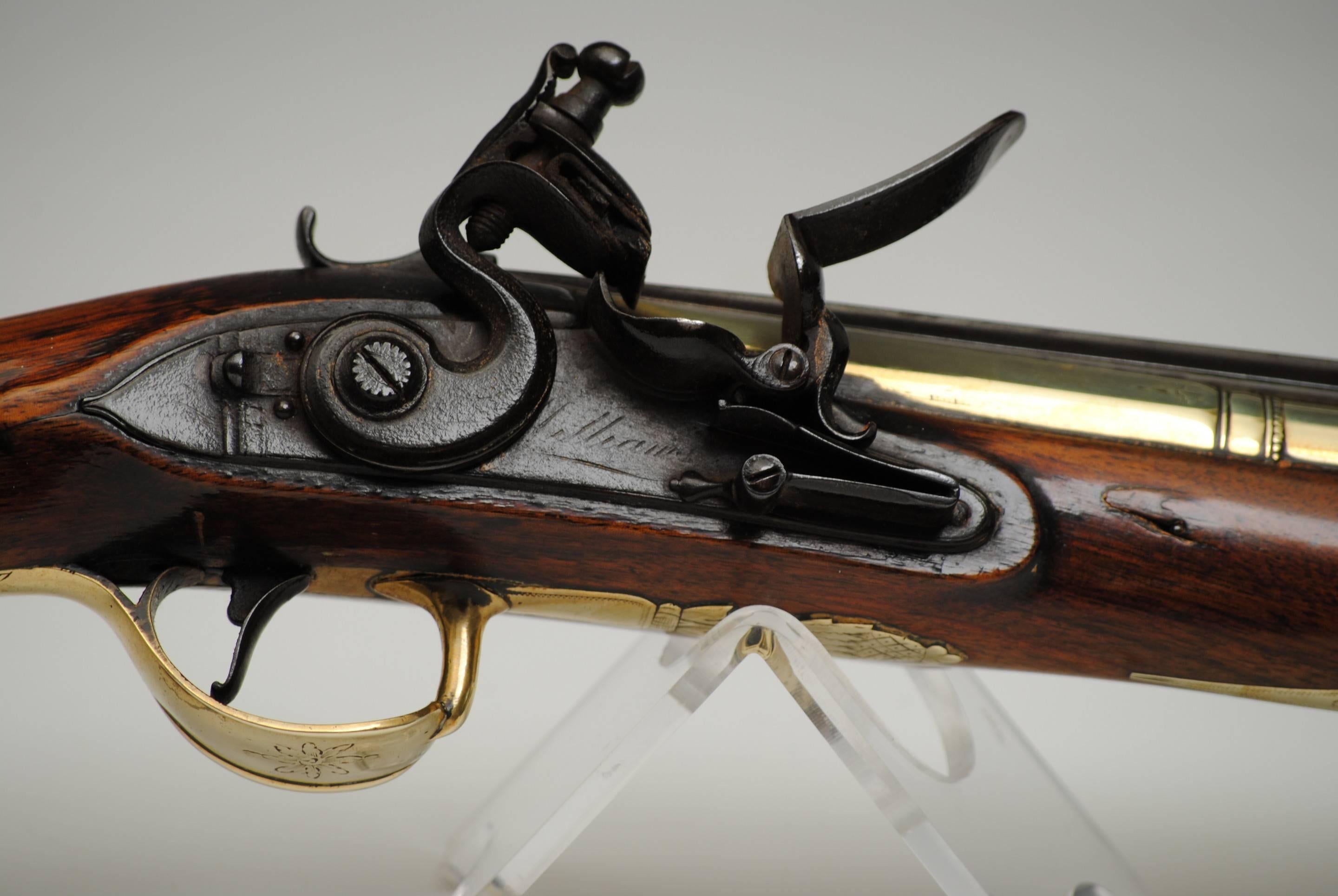 A good example of a three stage brass barreled flintlock blunderbuss by Wilson, in original condition with superb walnut stock.