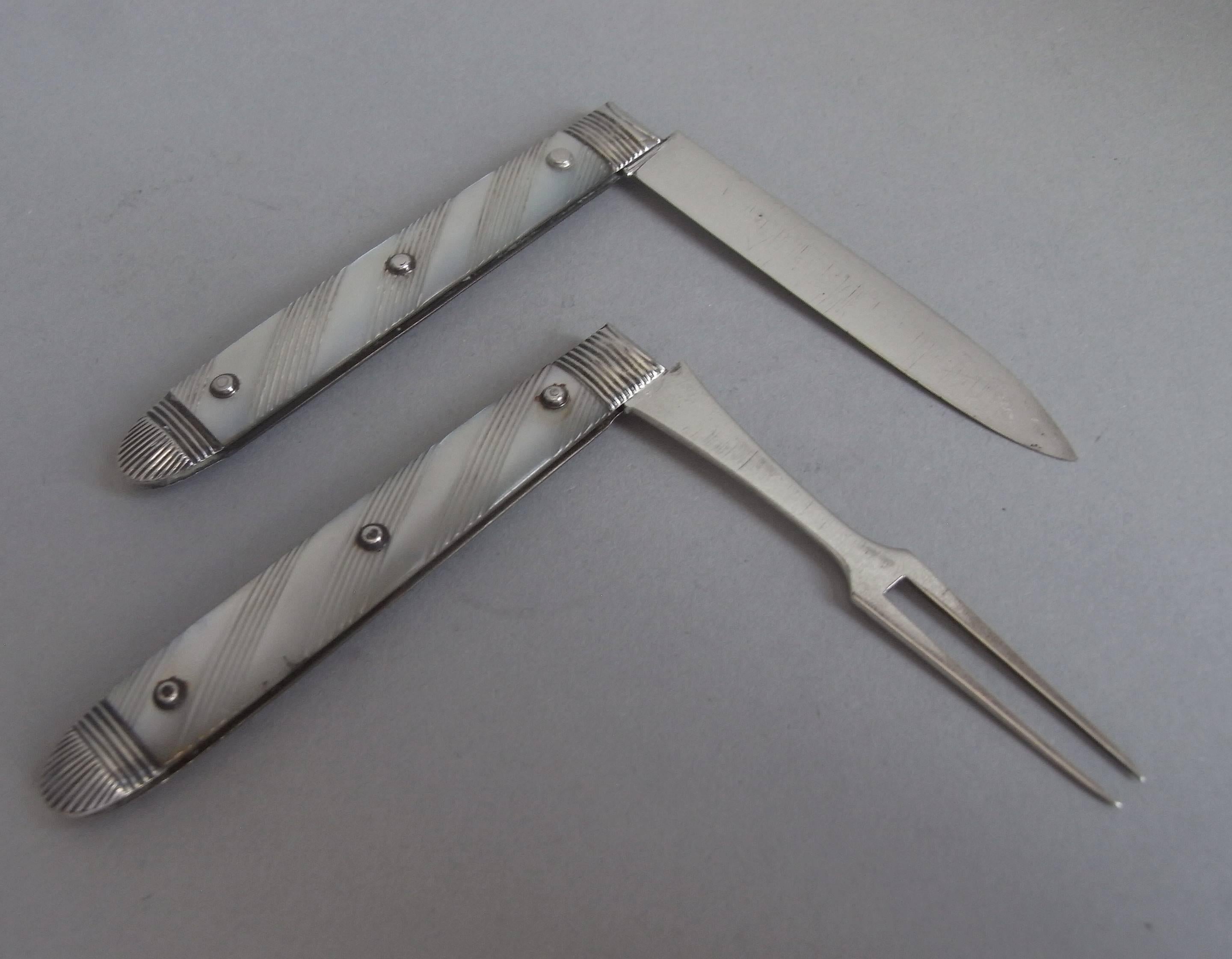 The fruit knife and fork have a silver blade and tines and reeded mounts. The mother-of-pearl handles are engraved with linear decoration and display silver stud work. Both are in excellent condition and are very well marked. They are contained