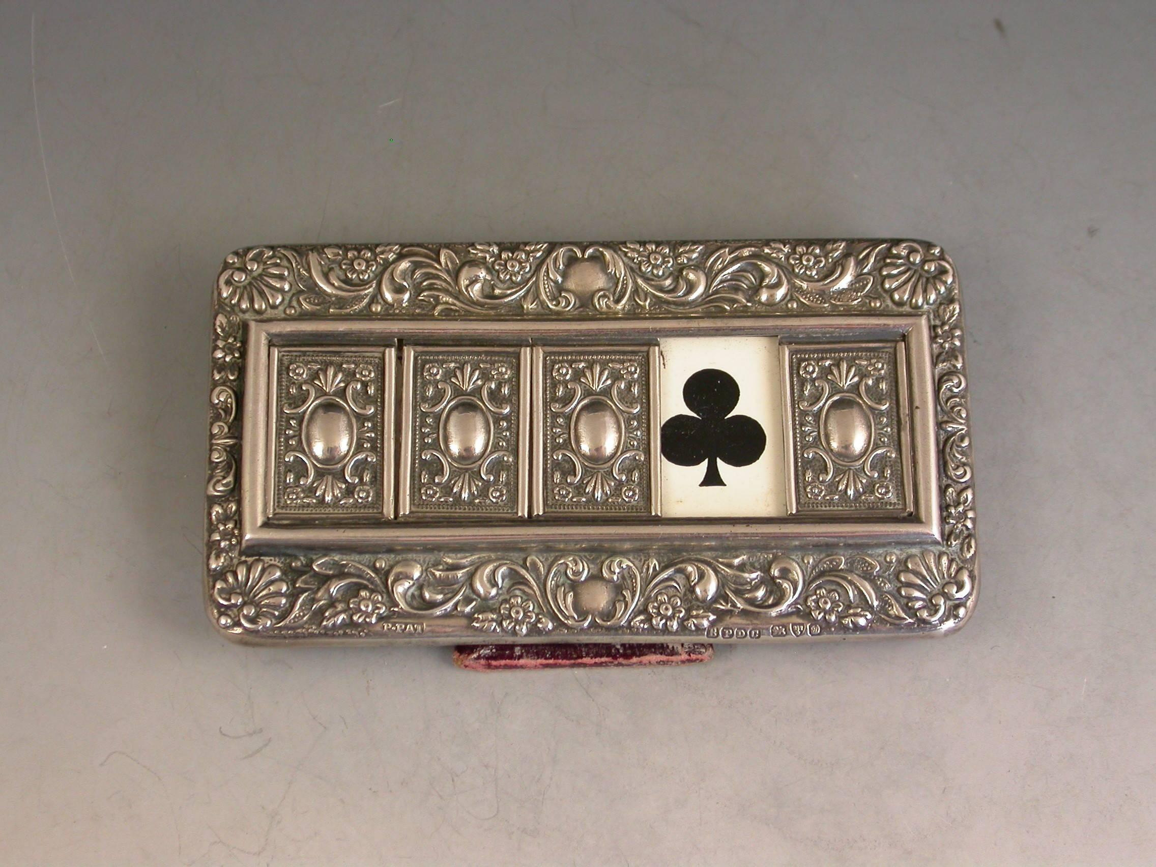 Good Edwardian Patented silver mounted trumps marker with red leather easel type back and stand, the silver frame with flower head, shell and scroll decoration, four sliding panels opening to reveal the trumps or no trumps painted on a celluloid