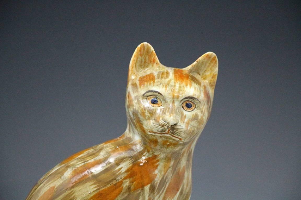 A rare Prattware pottery figure of a cat seated on a base.
Various colour variations exist of this figure and perhaps this Prattware example is one of the rarest and most decorative.
