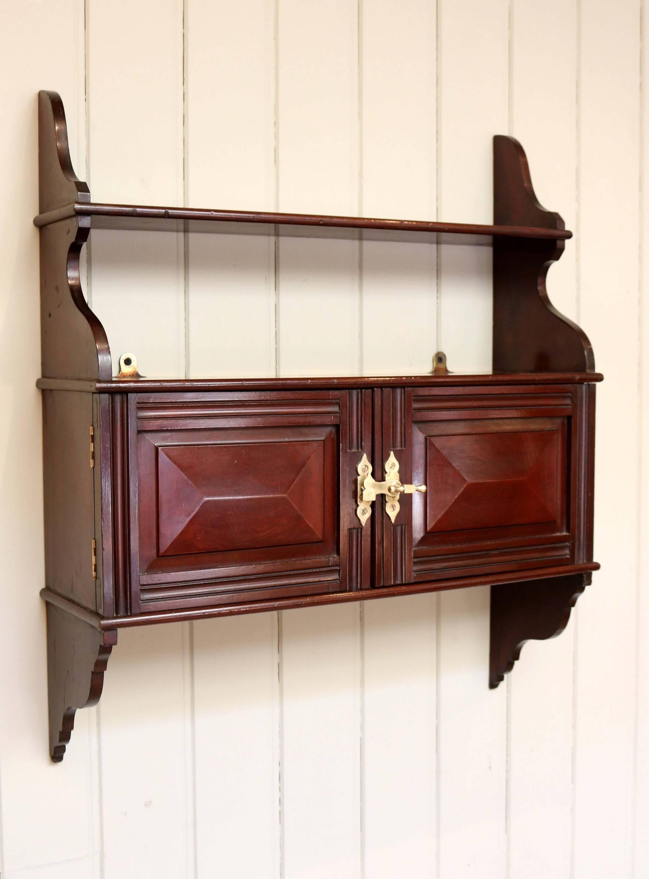 Edwardian mahogany finish two-door wall cabinet with an upper tier.
